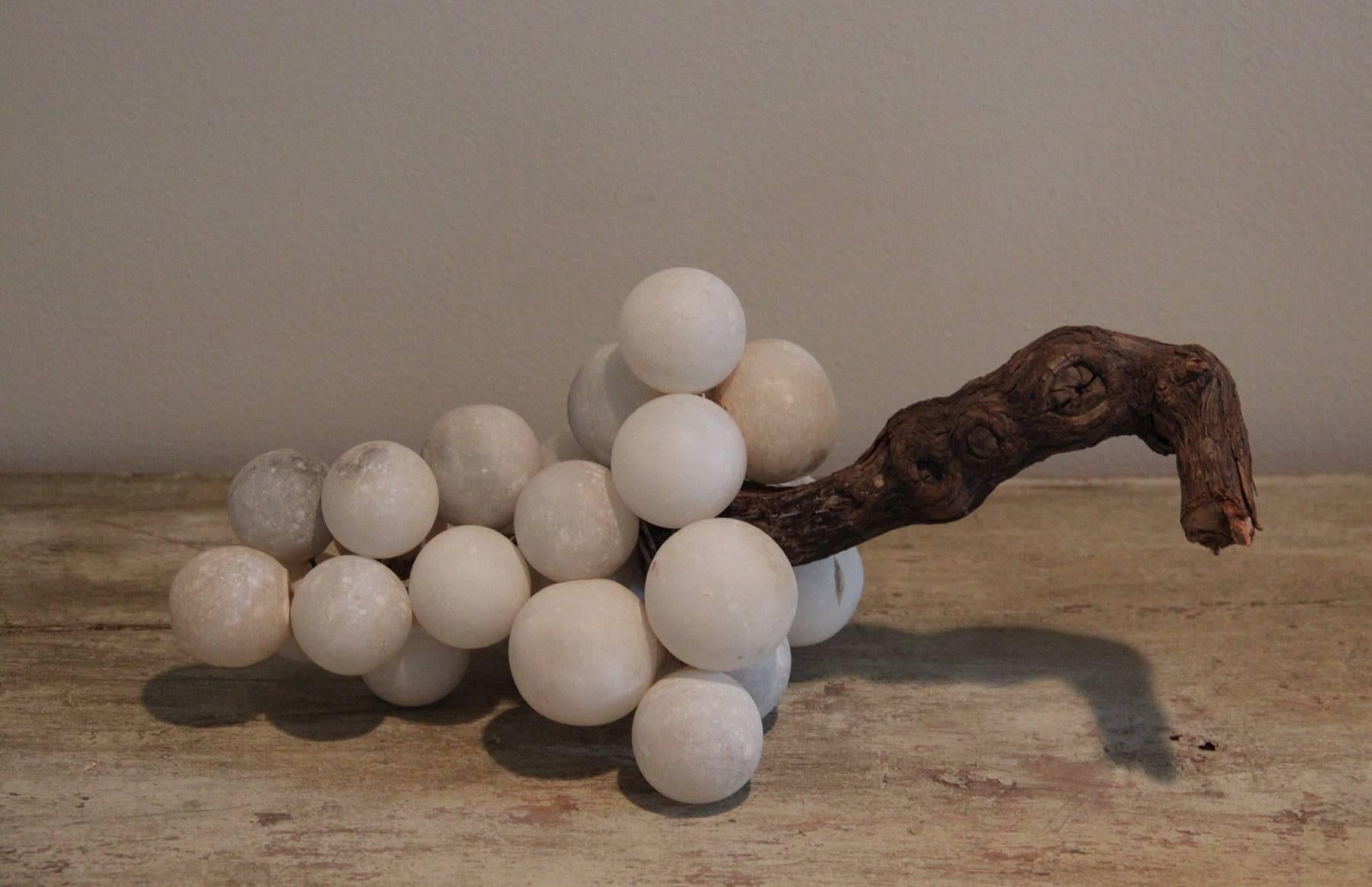 Maison & Co. loves the patina of these Mid-Century Italian alabaster grapes. Beautiful gray and ivory veining. Natural wood grapevine stem.  The stem can be shortened, if desired.

These grapes would work beautifully nestled in a bookcase or