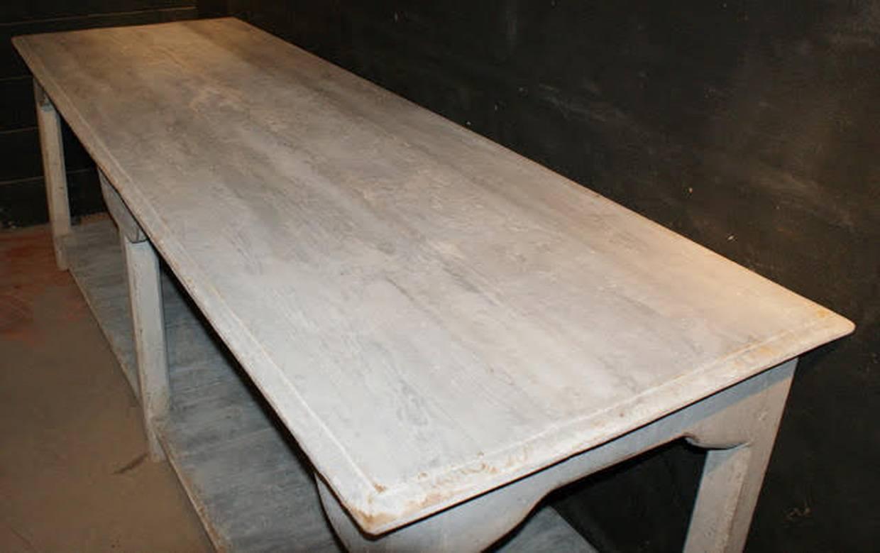 An impressive French draper's table with pot board. This beautiful table with an old, chalky, gray-white patina would make a wonderful kitchen island or console/serving table.