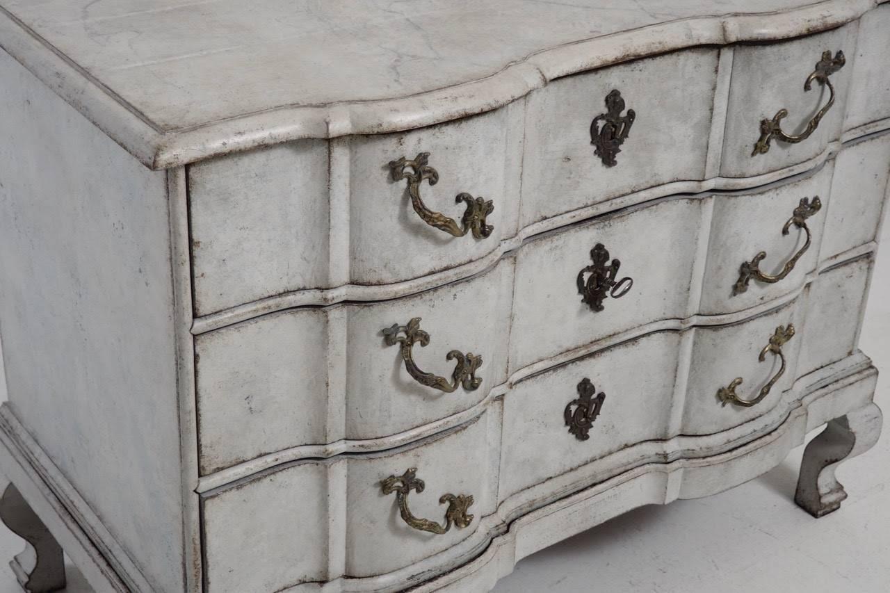 A Scandinavian Baroque period chest with hand-painted marbleized top and bronze hardware.