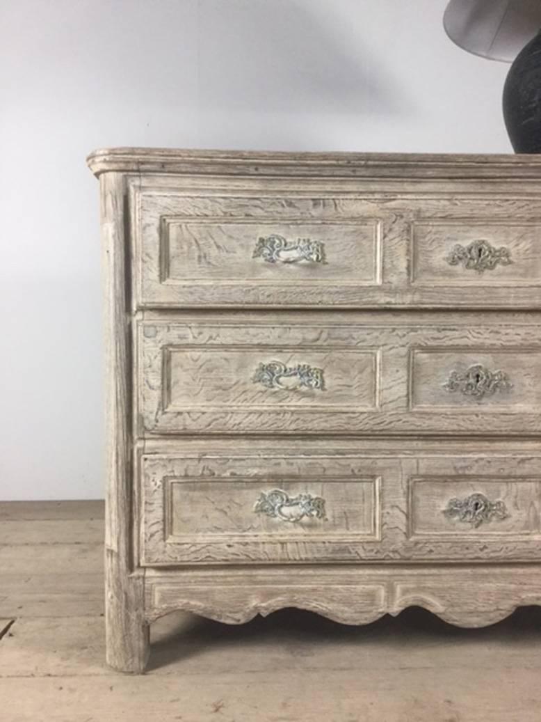 A beautiful French Louis XV style bleached and limed chest with three drawers and original brass drawer pulls.  This chest is in mint condition.  