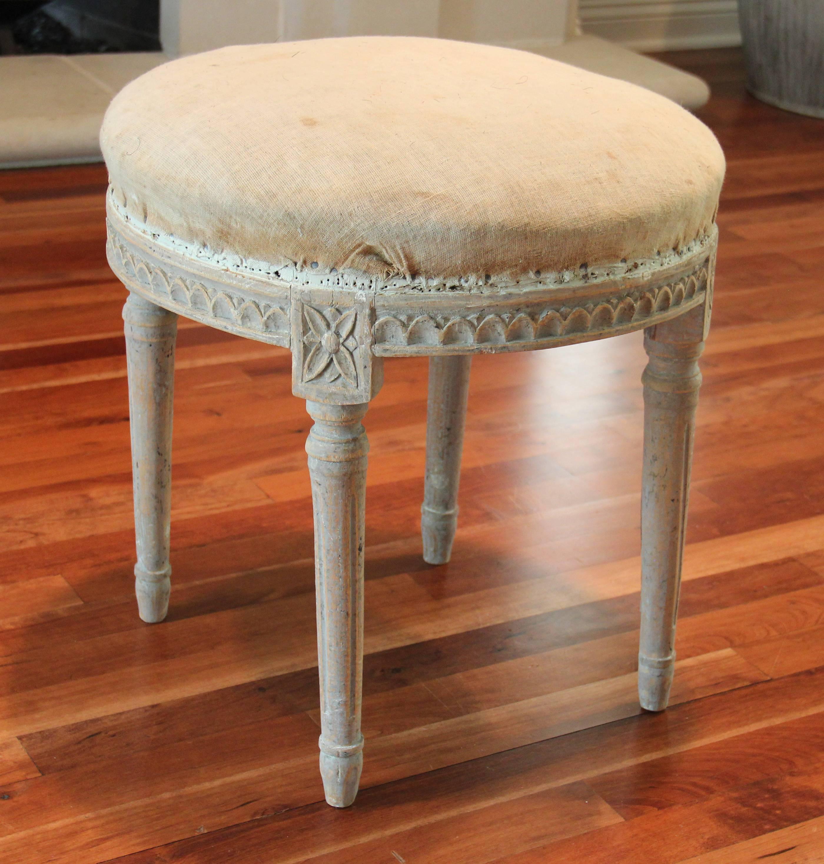 A very special Swedish early Gustavian period round stool with original horse hair seat.  This charming stool has retained its original Gustavian blue-gray paint.  There is carved egg-and-dart detail around the apron with tapered and fluted legs