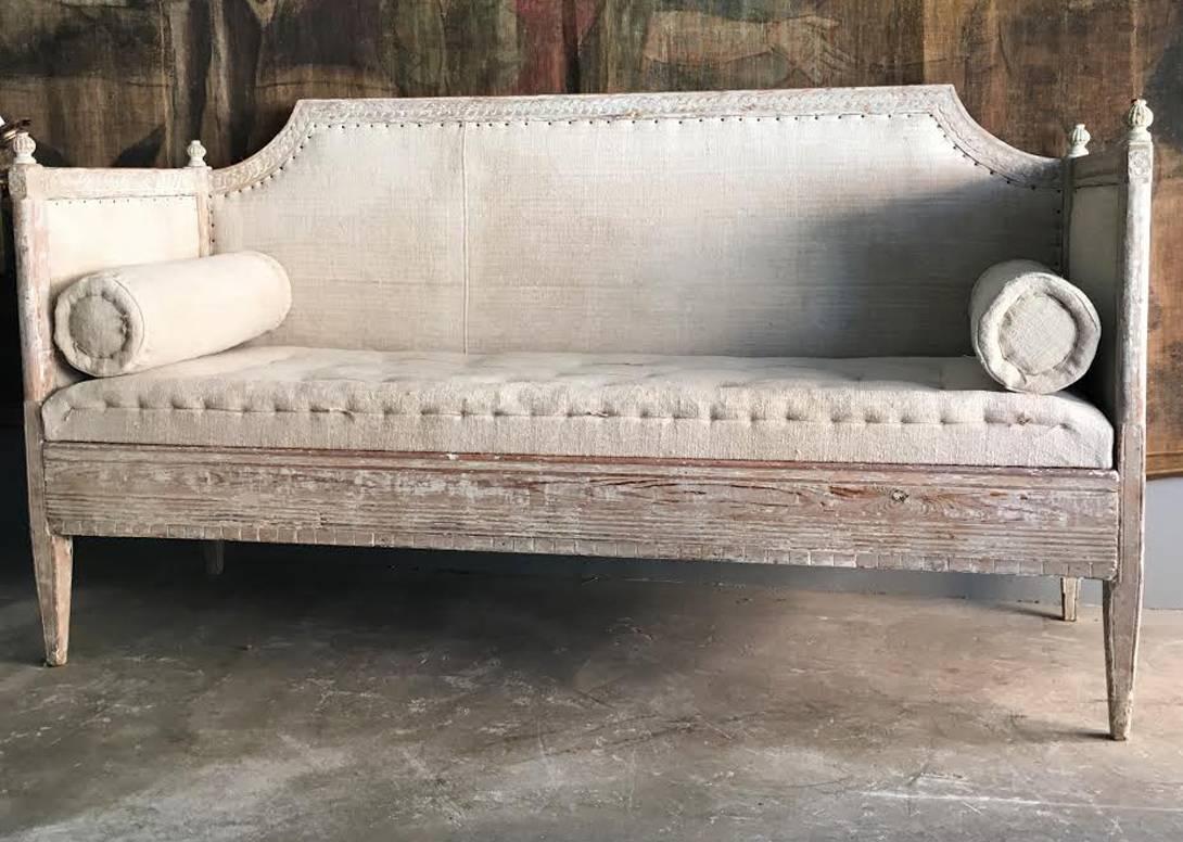 This exquisite 18th century Swedish Gustavian period sofa was found in the Provence region of France. It has been hand-scraped to reveal the original paint. The sofa is newly upholstered in vintage hemp linen with hand-stitched seat and bolster
