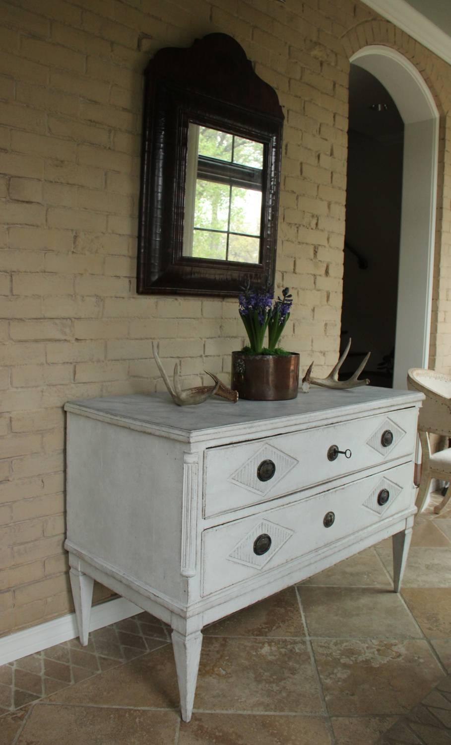 A Swedish painted chest of drawers from the Gustavian period featuring reeded lozenges on the drawer fronts.