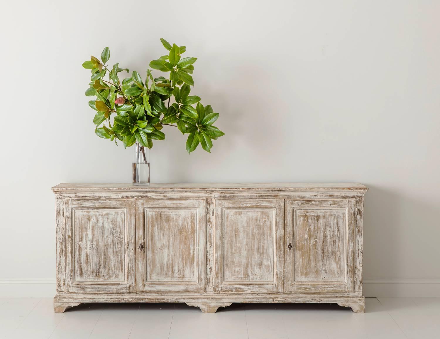 A 19th century French Louis Philippe enfilade found in Provence. This beautiful four-door sideboard or buffet has been hand-scraped down to its original paint, circa 1880. The interior back and sides are painted French blue and the shelves old