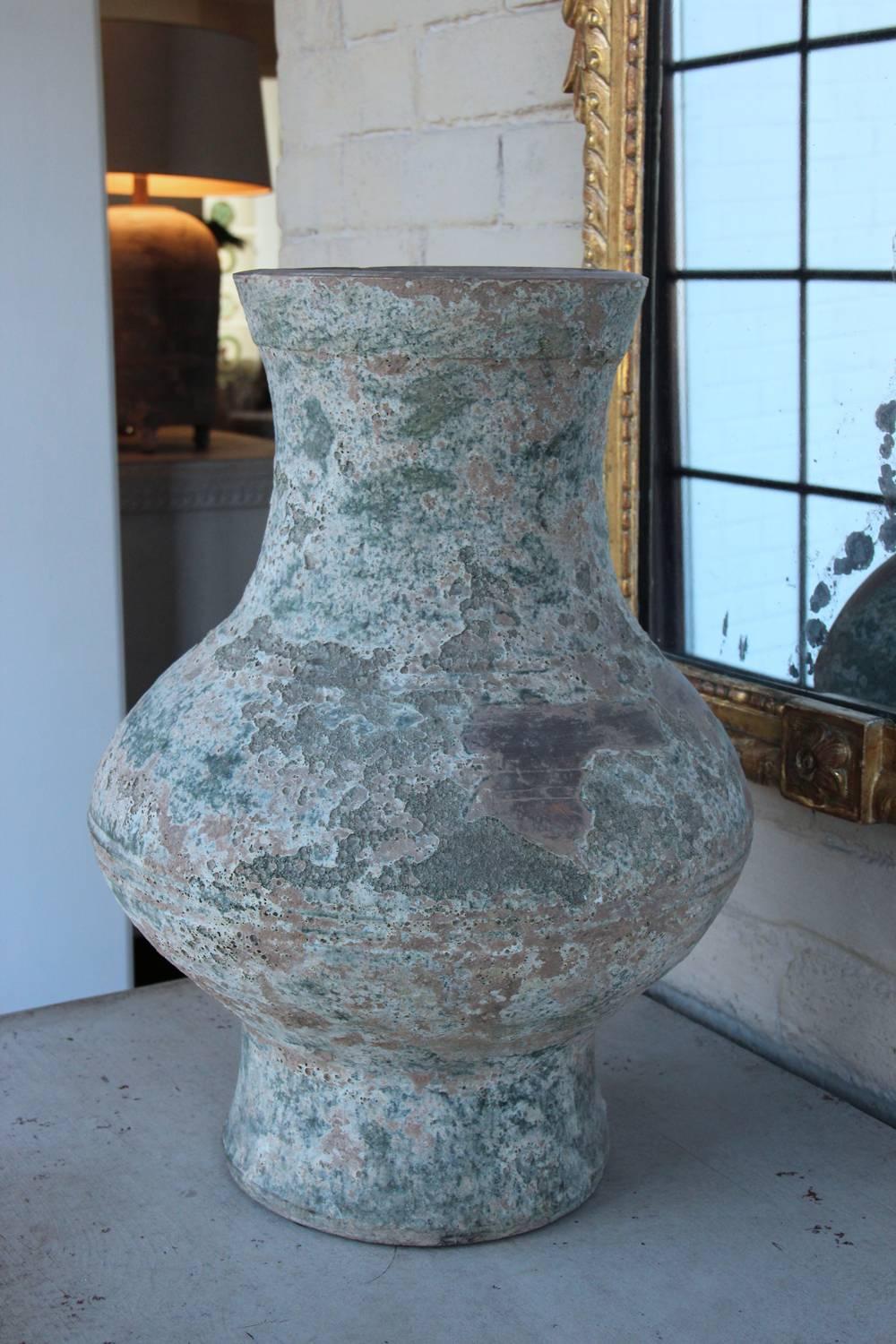 To view more of our inventory, visit Maison & Co.'s 1stdibs storefront.  This is an exceptional Chinese glazed terra cotta vase or jar, known as 'Hu' from the Han dynasty period used to store wine, oil, and grain. There are incised rings around the