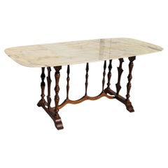 Mesa de comedor ovalada de estilo italiano con tablero de mármol y base de madera torneada