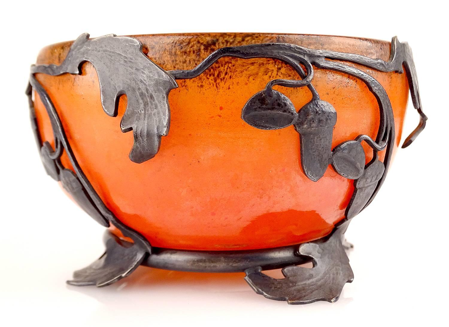 Early French Art Nouveau (circa 1890) glass bowl (clear blown glass with applied orange enamel) on wrought iron base by VAL Paris and Daum, France, circa 1910.

Art Nouveau is French for new art. The term was originally used in various articles