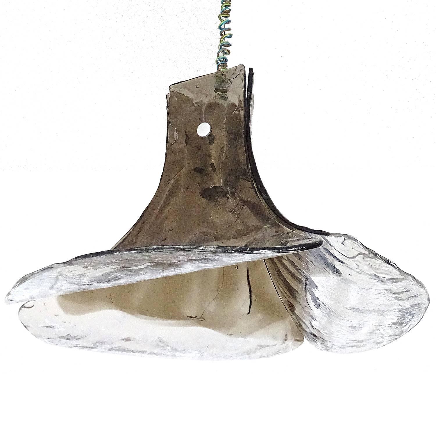 Pendant lamp model ‘LS 185’ by Carlo Nason for Mazzega. It consists of four handmade pieces of thick Murano glass, suspended from a metal hanging frame, flaring outwards at the bottom to simulate the shape of a flower. The color at the top of the