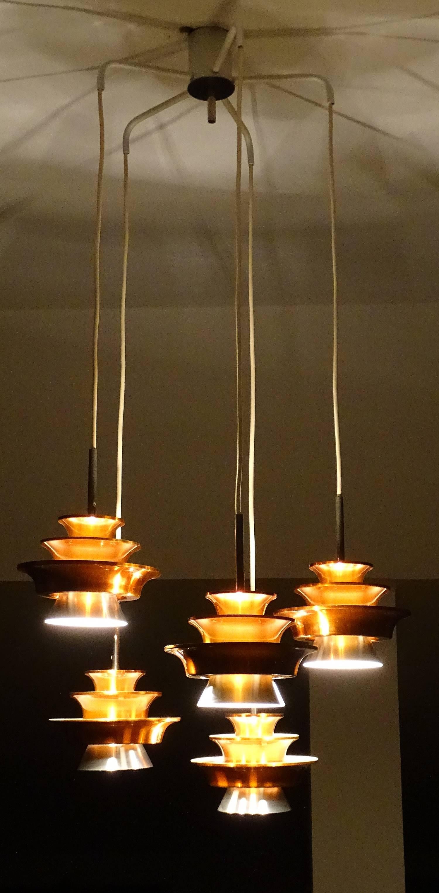 All our lights electricals are checked and tested with 110 and 220 Volts bulbs

Five-Tiered Danish Lyfa  Chandelier pendant light.Each light made out of 4  stacked aluminium shades, the three uppermost with a copper colour.  

Dimensions
41.34 in.H