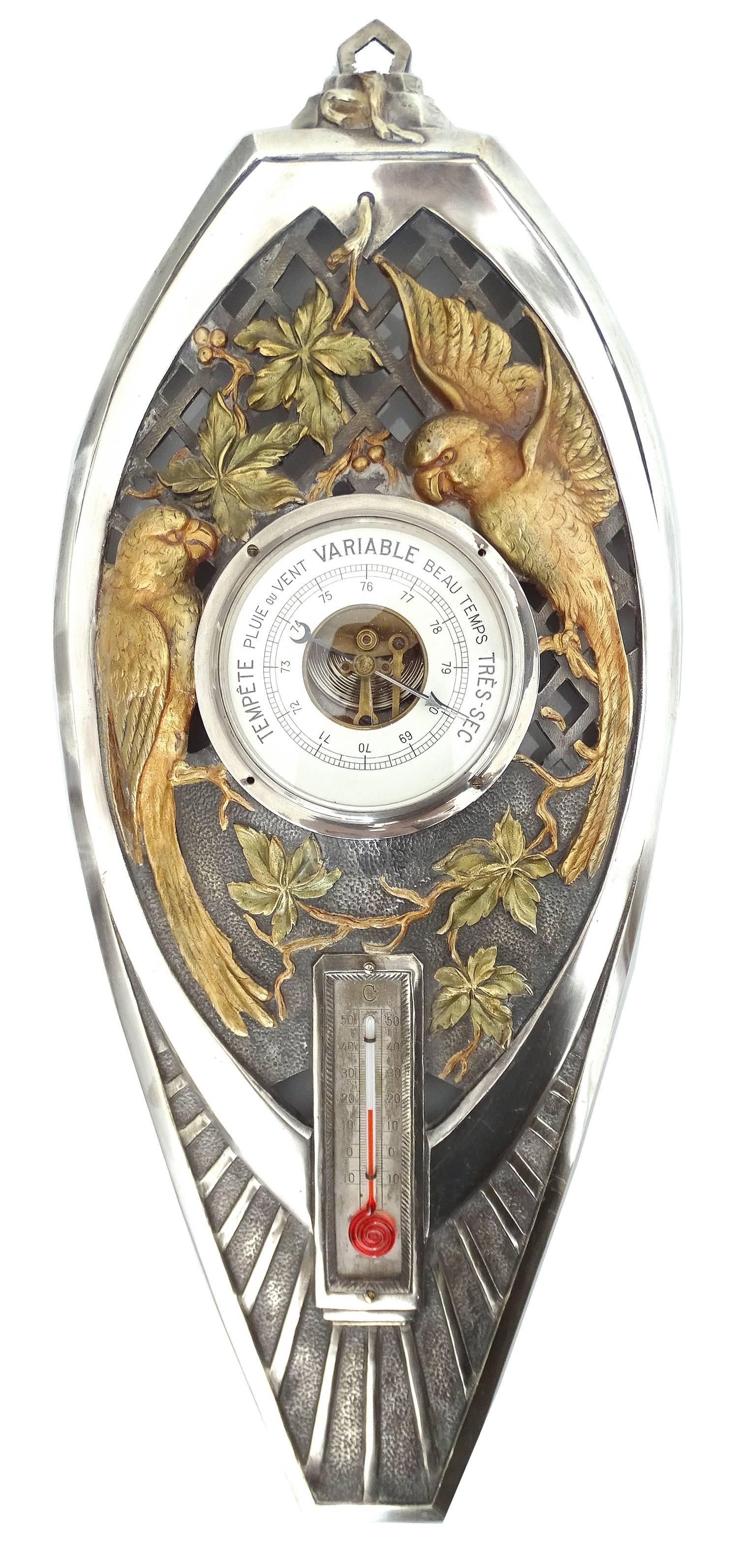 Extremely rare silver plated French Art Deco modernist weather station.

Very large design, quintessential French Art Deco featuring a pair
 of parakeet or gold conures against a leafy background, bottom section with radiating pattern.

Great