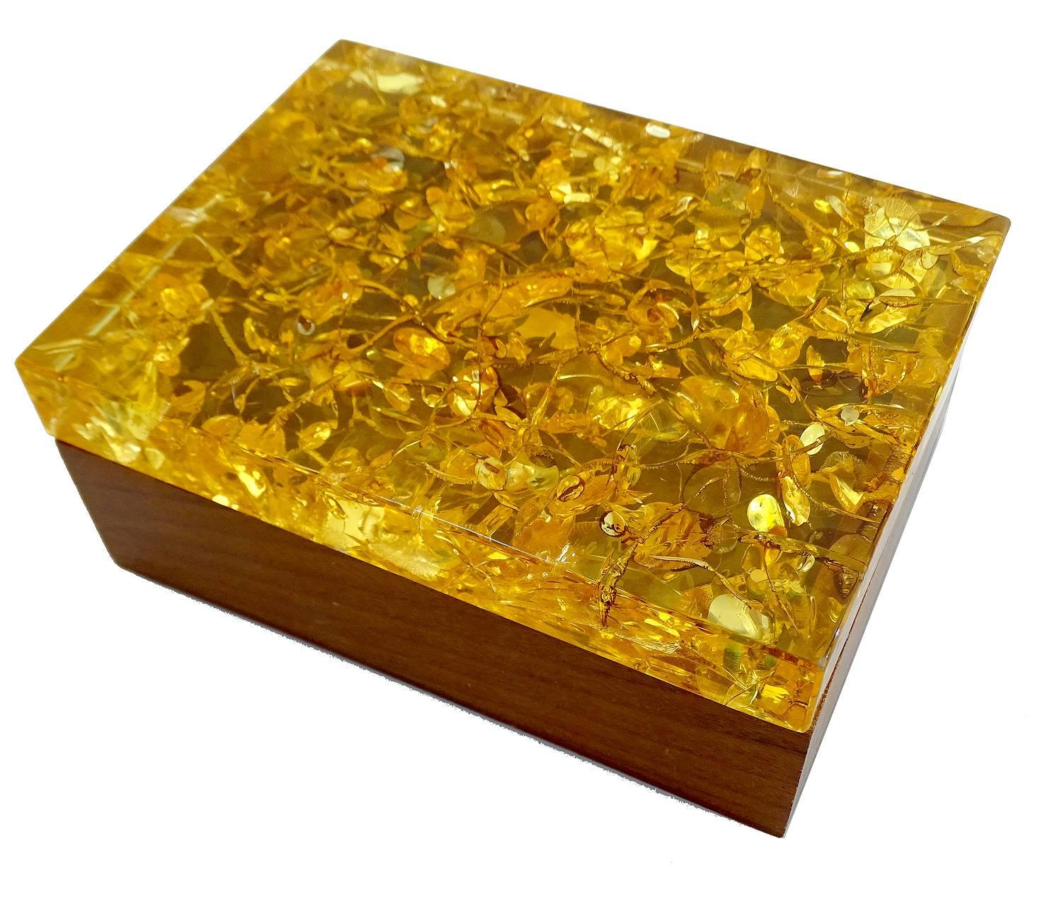 French Mid-Century vintage box / case made out of teak with a thick fractal resin lid with inclusions to emulate amber stone, 

Stunning warm and sparkling colors when exposed to sunlight.