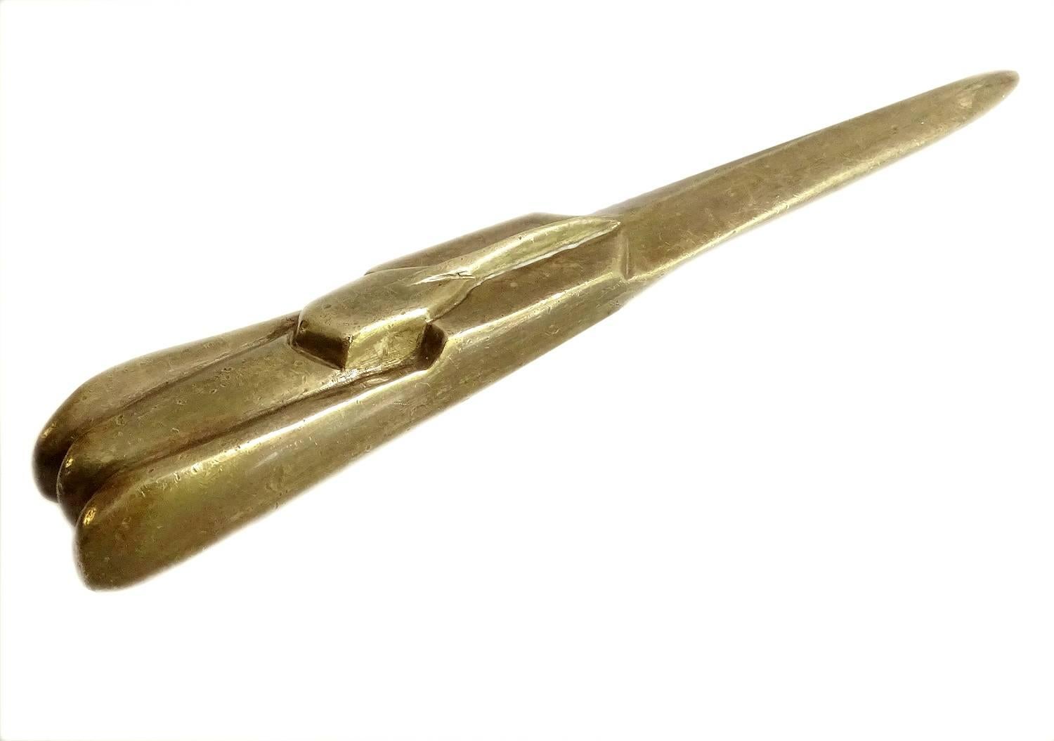 This amazing sensual and sculptural heavy polished bronze letter opener, desk accessory or object features a swooshing car in the style of the streamlined automobiles of the 1930s, think of Bugatti or Delahaye, manufactured, circa 1935 in France,