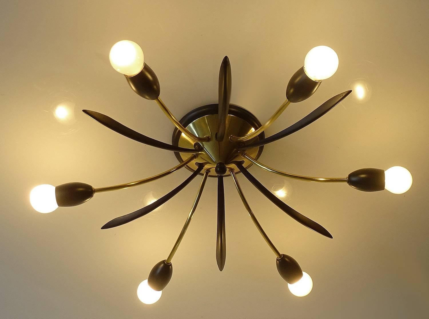 All our lights electricals are checked and tested with 110 and 220 Volts bulbs

A Mid-Century Sputnik chandelier, flush mount light with six brass spokes
and black enameled fittings intertwined with six black enameled petals
ceiling plate

Six