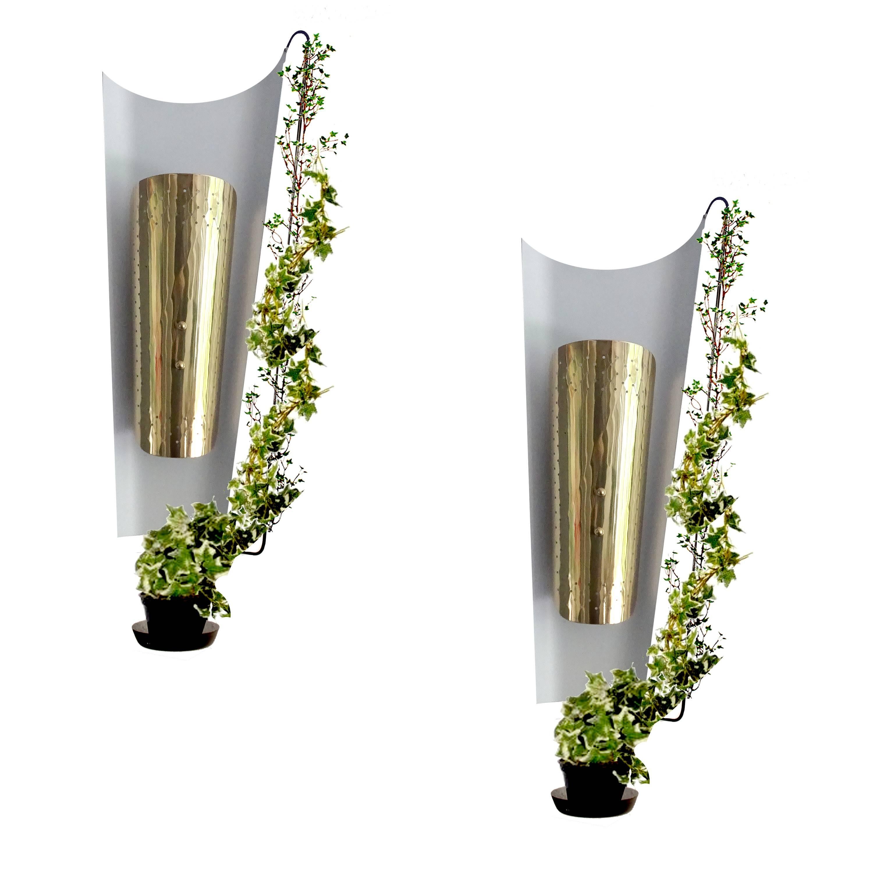 Exceptional pair of  very large  French, architectonic modernist sconces by Arlus. They  feature a dramatic white enameled asymetric sail alike backdrop piece, (the back is black),  a central louvered brass reflector with both ends curved,  and