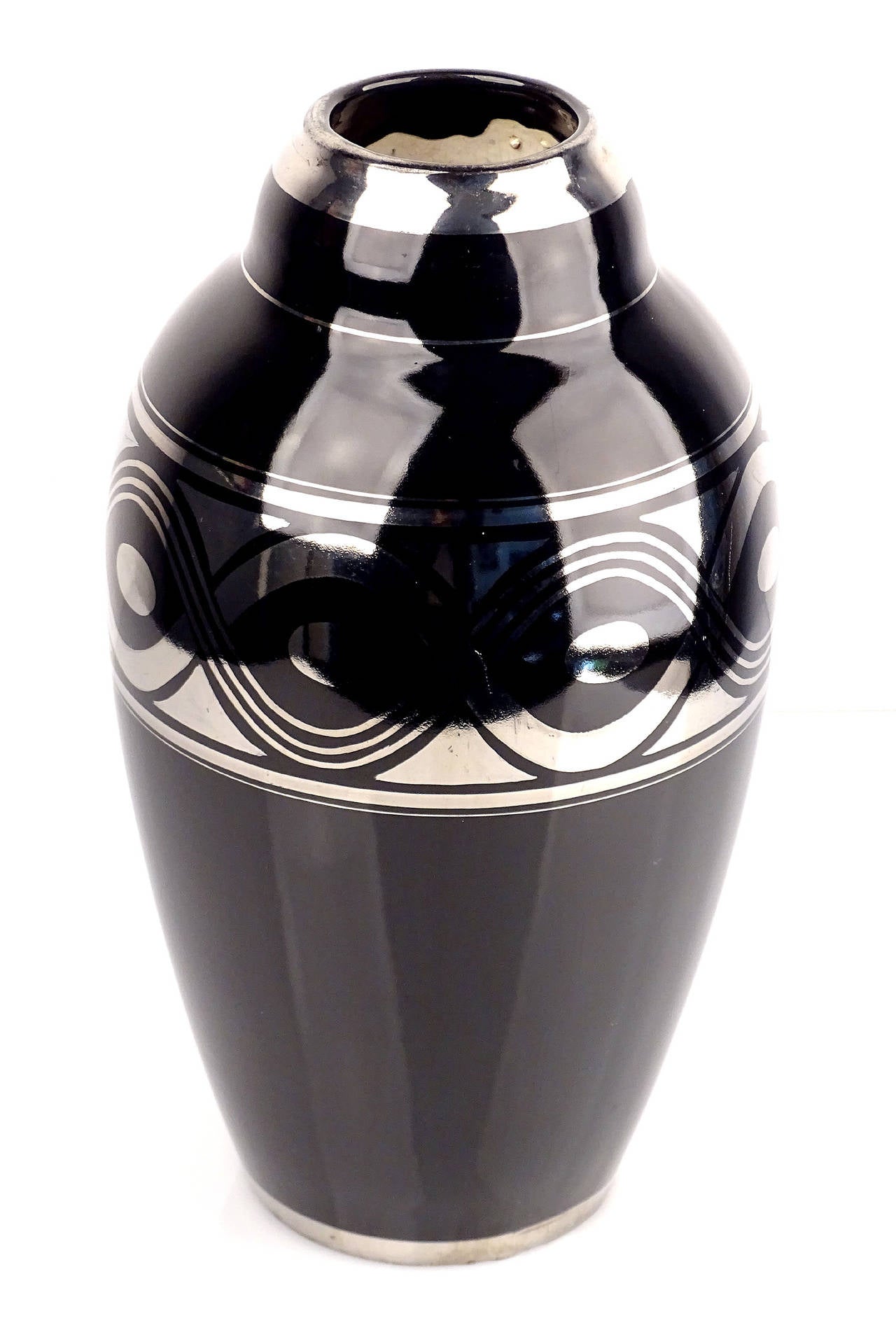 Large and elegant Art Deco amphora shaped vase, France, 1930s. Black glaze with geometric frieze style ornaments in chrome silver.
Dimensions
H 11.82 in. x Dm 9.45 in.
H 30 cm x Dm 24 cm










The Art Deco style name was derived from the