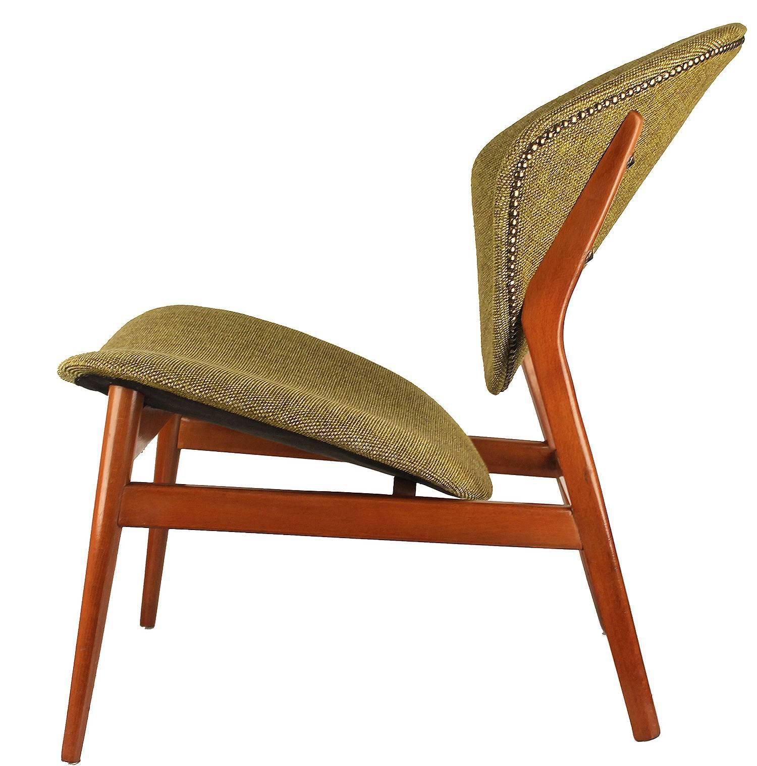 Fantastic pair of mid century chairs with an sculptural form to be appreciated from all angles, where the petal-like back and seat shells are mounted on a tapered wooden frame . The sweeping contoured shells appeared to be poised on or cantilevered