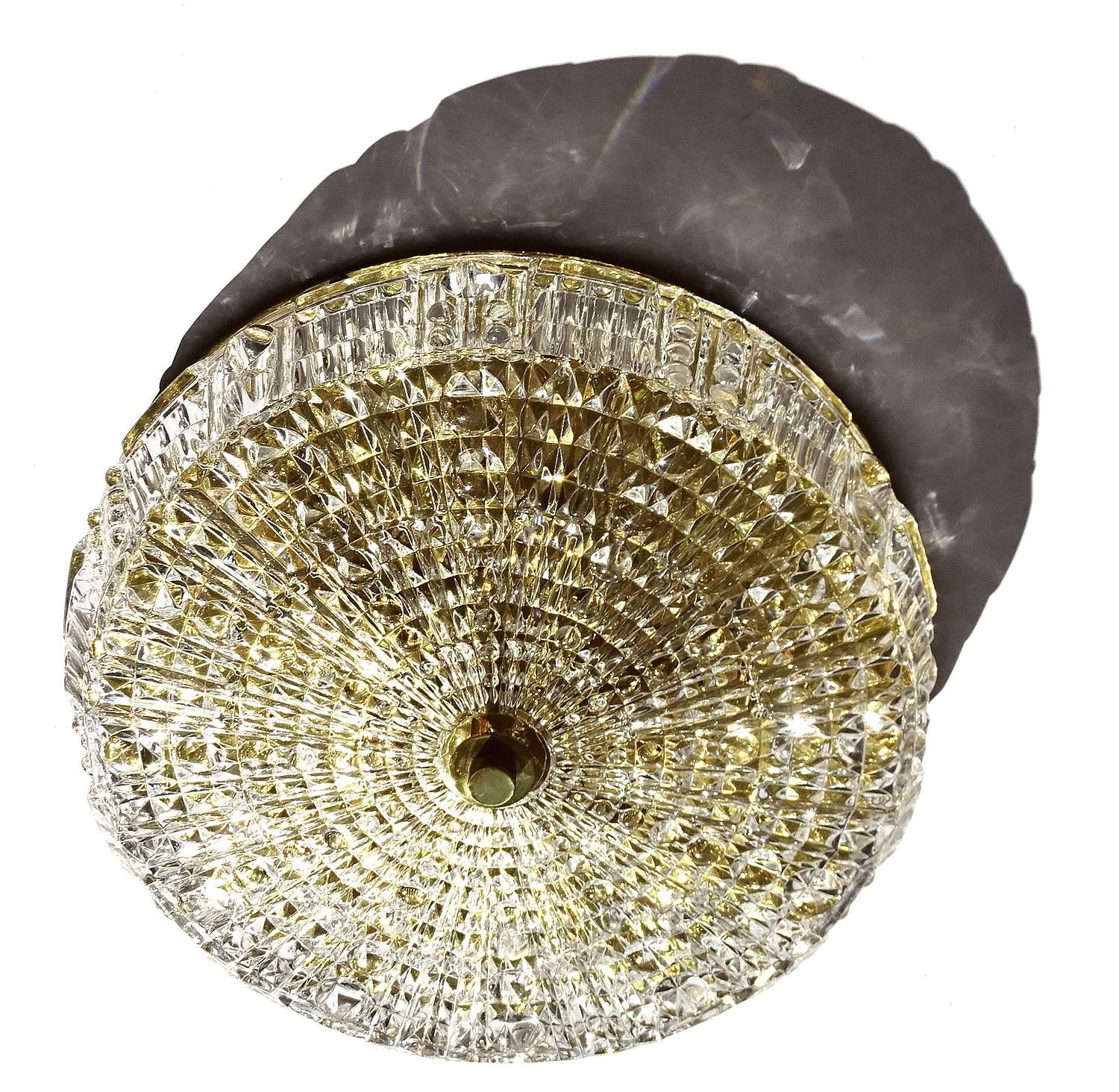 Orrefors Crystal Flush Mount Light by Carl Fagerlund,  polished brass base
4.72 in.H / 12 cmH
Diameter
14.96 in. (38 cm)
Five candelabra bulbs, 40 watts each-

With the 1960s came the accentuated use of glass elements and vintage Italian lights
