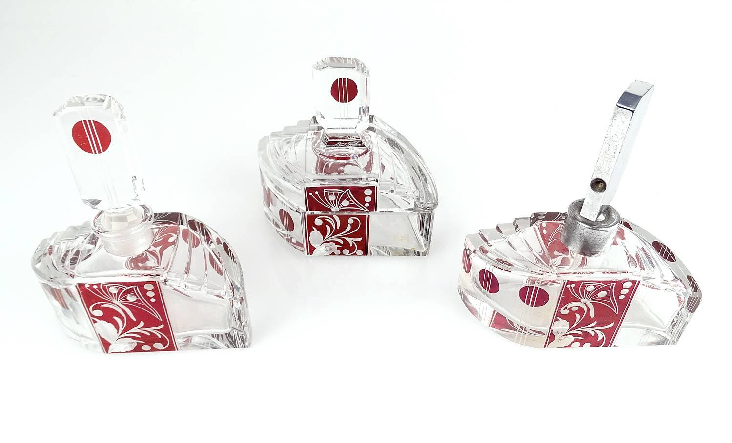 Exceptional Art Deco Karl Palda Bohemia crystal vanity set
with powder box, perfume bottle and eau de tollette spray
stunning Art Deco details like the streamlined shape of the
containers, with revolving staircase shoulders, engraved