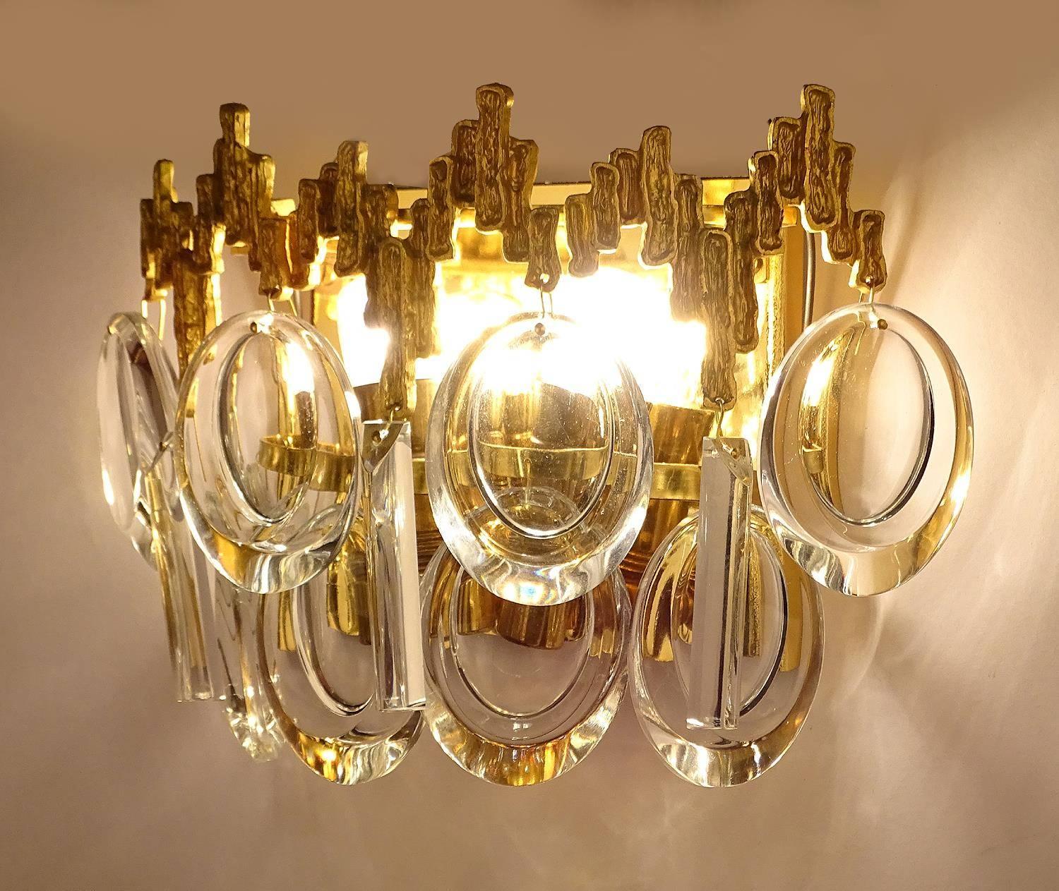 Exceptionnal  pair of vintage Mid-Century  sconces by Palwa. The lights feature a gilded base with a stupendous  tiara style crest with brutalist trim and and 2 rows of  creole style crystals,  models which were produced in extremely small output