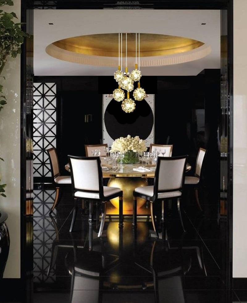 Large 3 tiers cascade pendant light by Limburg, design by Helena Tynell, with seven hand blown glass globes (three small and four large ones,) glass has different level of amber coloring with brass finials,  bronze enameled suspension

The