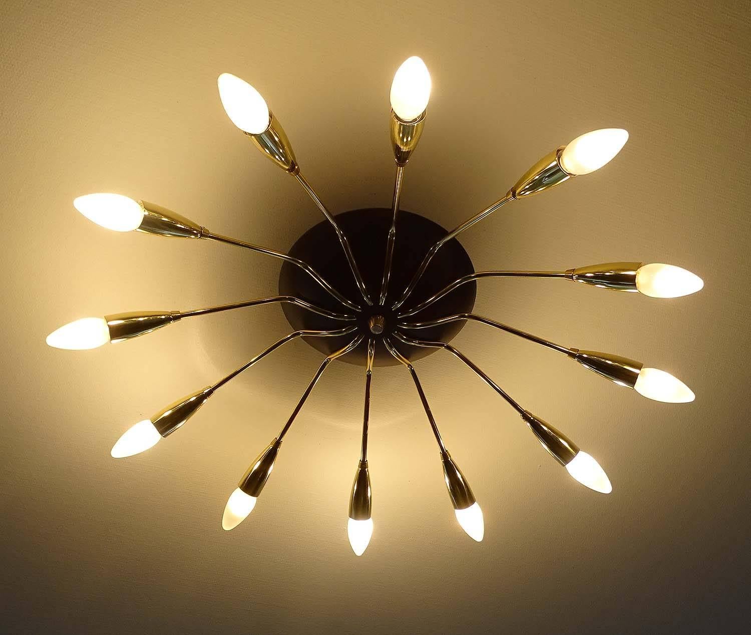 Dimensions
5.91 in.H / 15 cmH
Diameter
29.53 in. (75 cm) Diameter indicated is with the bulbs. 

Twelve candelabra size bulbs, 40 watts each. Rewired - LED compatible 

Large 1950s sunburst Sputnik chandelier, 12 brass curved spokes flush mounted on