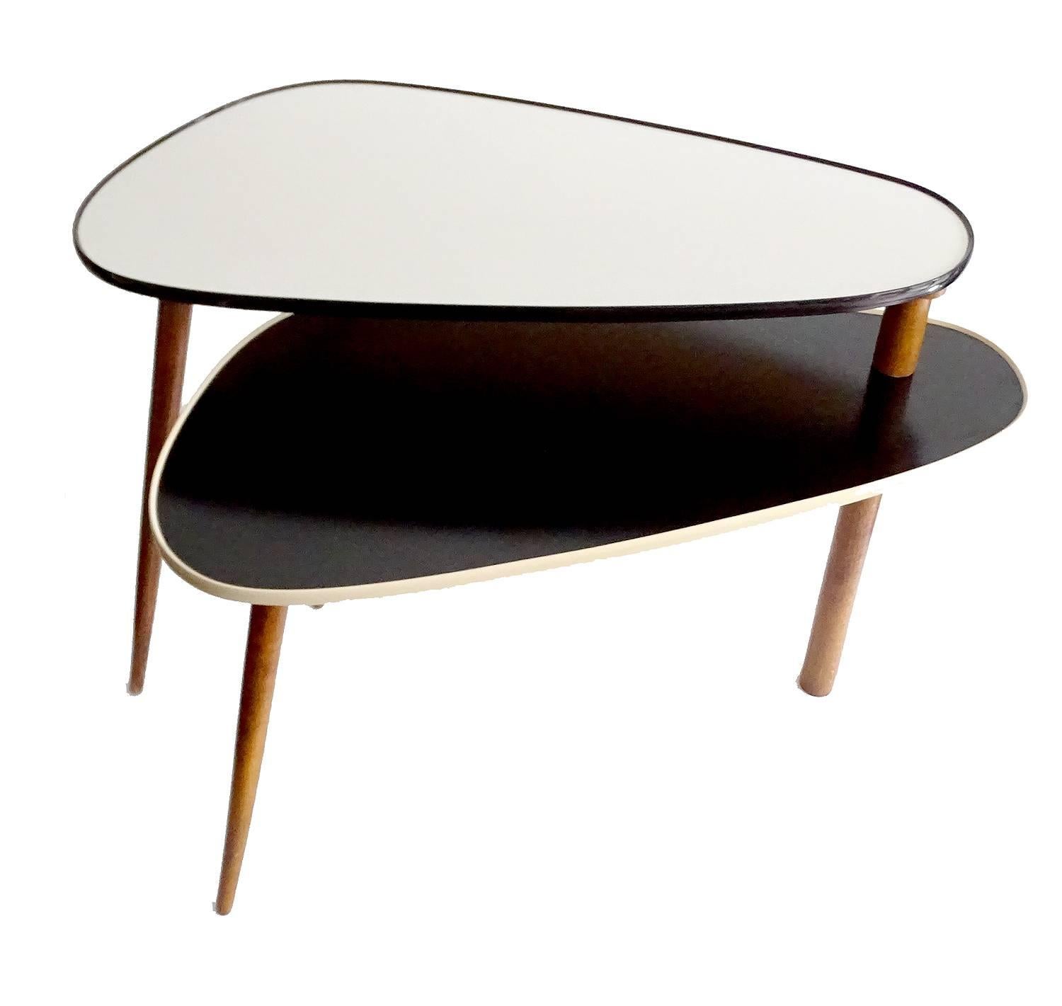 Stunning Mid-Century, 1950s double leveled, modular table which offers a multitude of possible combination,.

An extremely rare design featuring two oval shaped levels with black and white synthetic laminate, connected at the back on a single pole