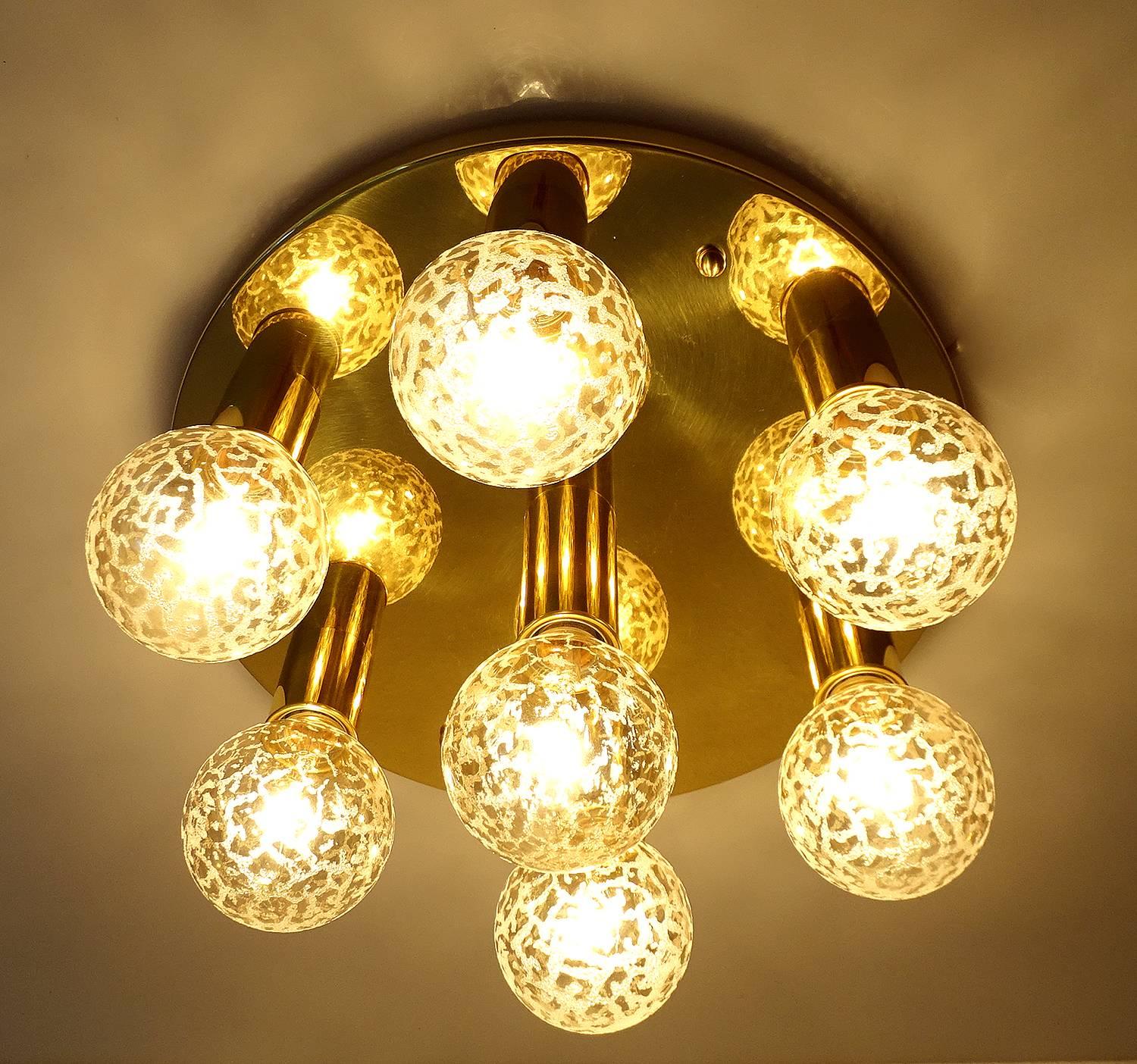 Large Mid-Century flush mount light with seven lights , polished  brass base 
 11.02 in. / 28 cm H (with bulbs)
Diameter
17.72 in. (45 cm).
7 bulbs with max 60 watts each - - rewired


Italian lights manufacturing companies  had a strong influence