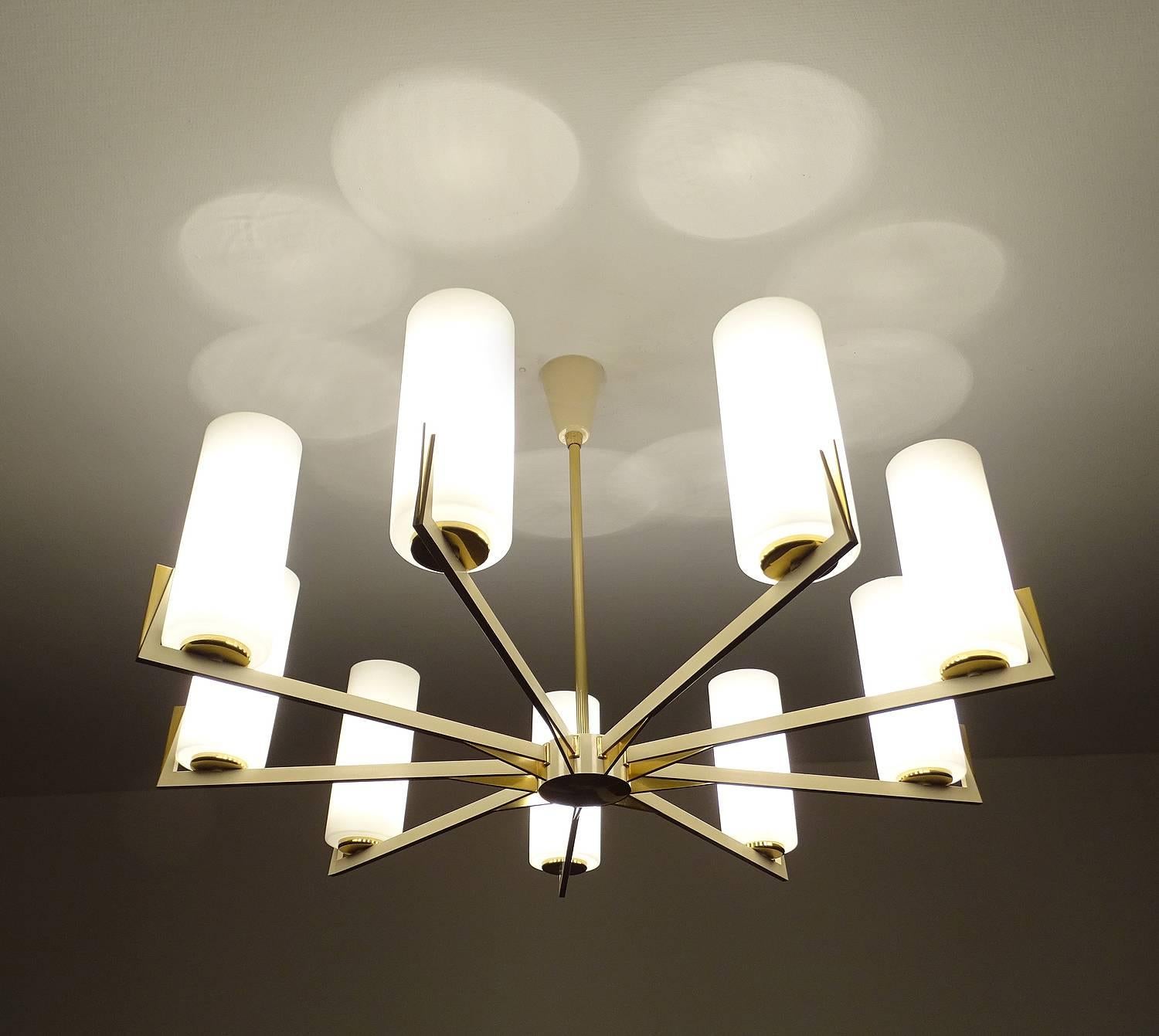 Very large original 1950s sunburst chandelier in the manner of Arredoluce, brass and cream white lacquered structure, unusually large opaline glass diffusers. High end all brass quality.
29.13 in.  /  74 cm H
DIAMETER
34.64 in. / 88 cm 
Nine