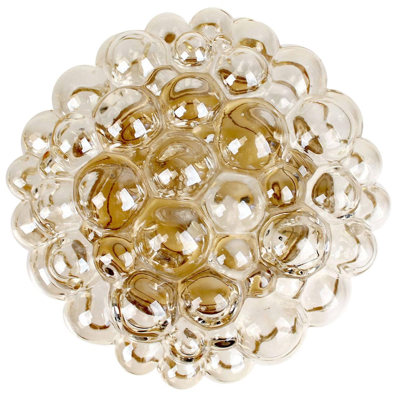 Limburg blown glass sconce, design by Helena Tynell, glass has slight amber color, bronze enameled base 
5.51 in. / 14 cm H
Diameter
12 in. / 30 cm 
Two standard bulbs up tp 60 watts each


With the 1960s came the accentuated use of glass elements
