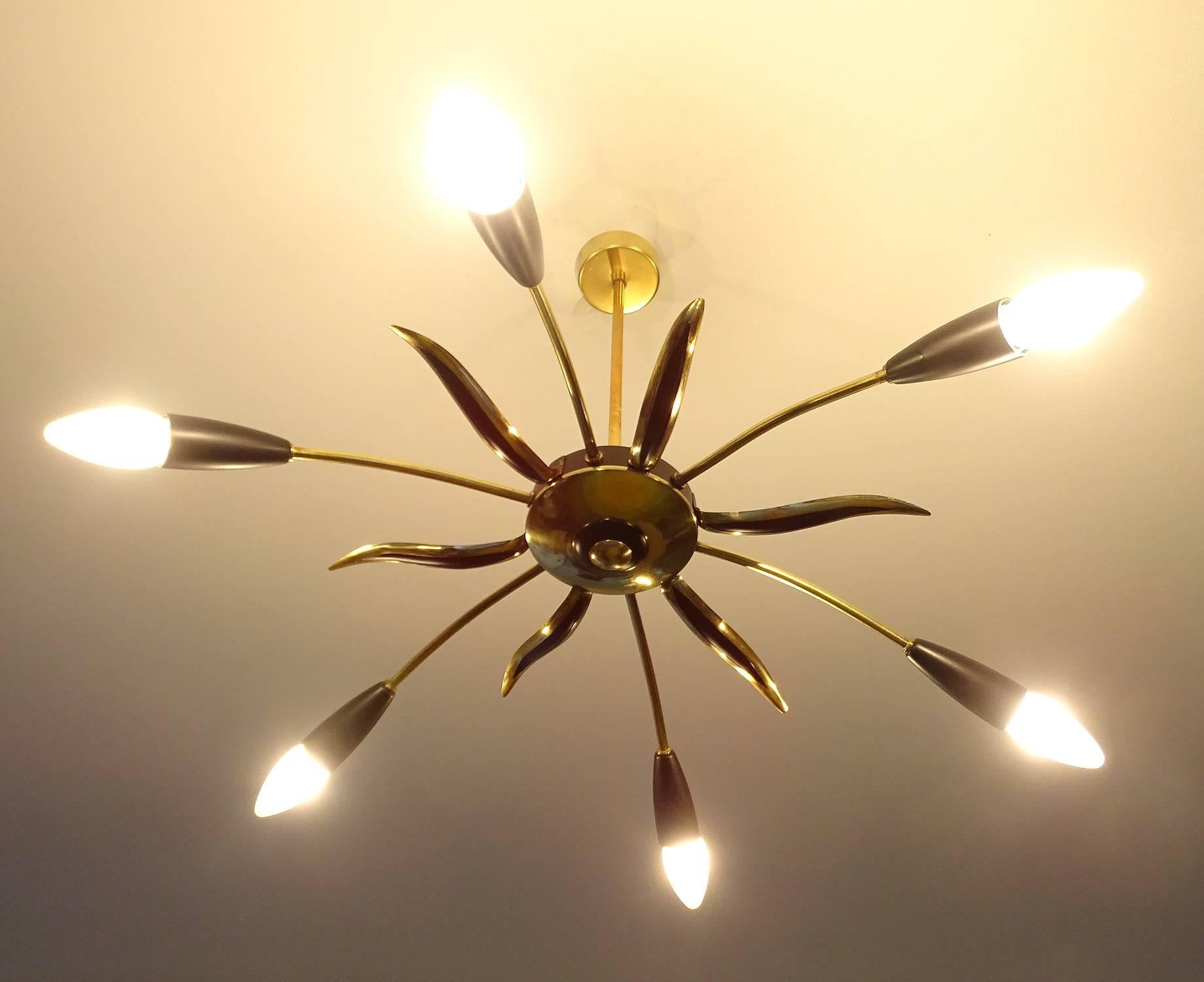 Austrian mid century flush mount light with a sunburst theme 1950s Satinated black and brass structure 
19.69 in. / 50 cm H
Diameter
28.3 in. (72 cm) (with bulbs)
Six candelabra size bulbs, 40 watts each


Vintage Italian lights manufacturing