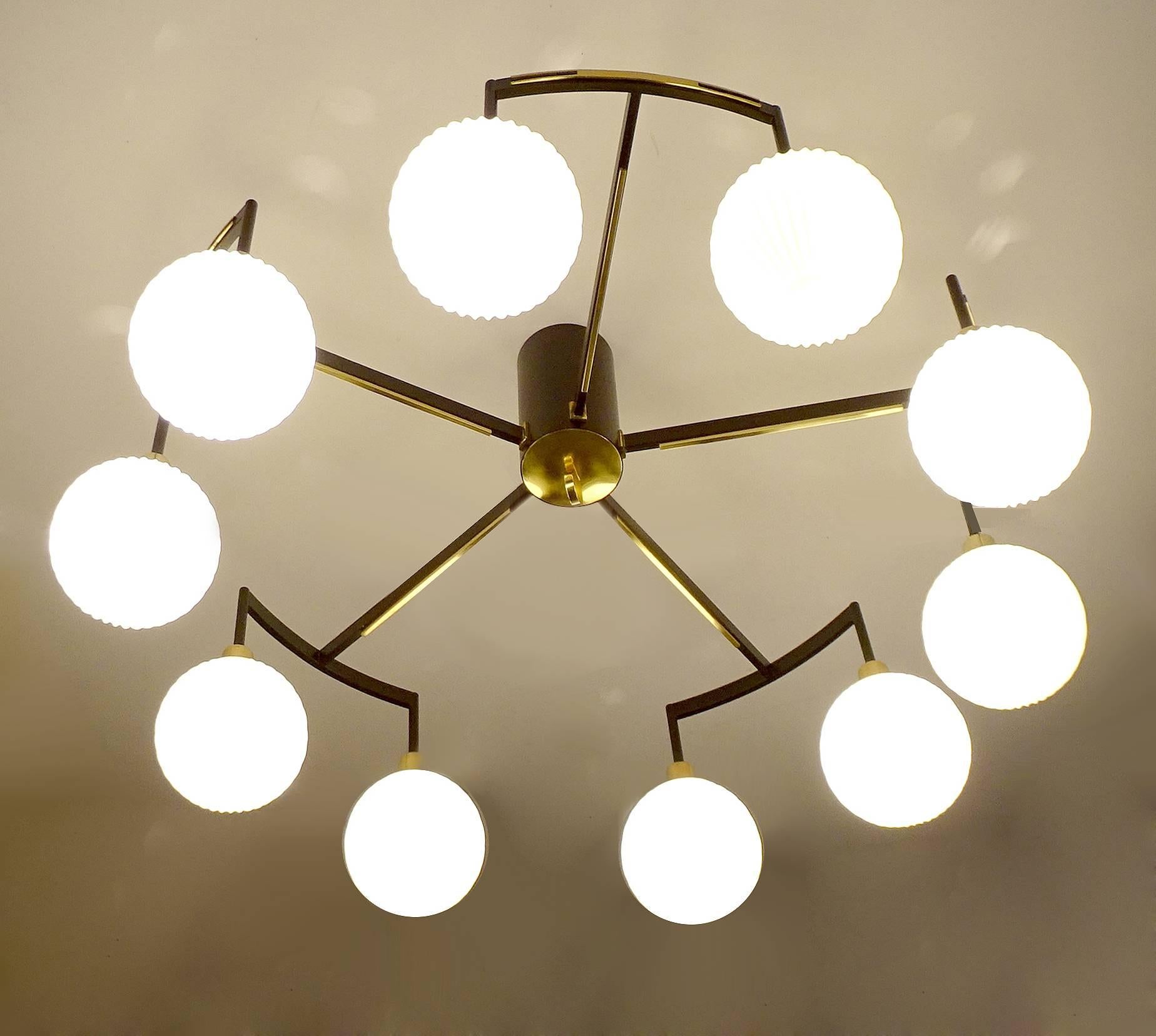Large Stilnovo flush mount chandelier, 1960s, black enameled and brass structure with 10 opaline ribbed glass globes.
Height
33.46 in. / 35 cm
Diameter
 13.78 in. / 85 cm 
10 candelabra size bulbs, each 40 watts -  rewired, may require some hardware
