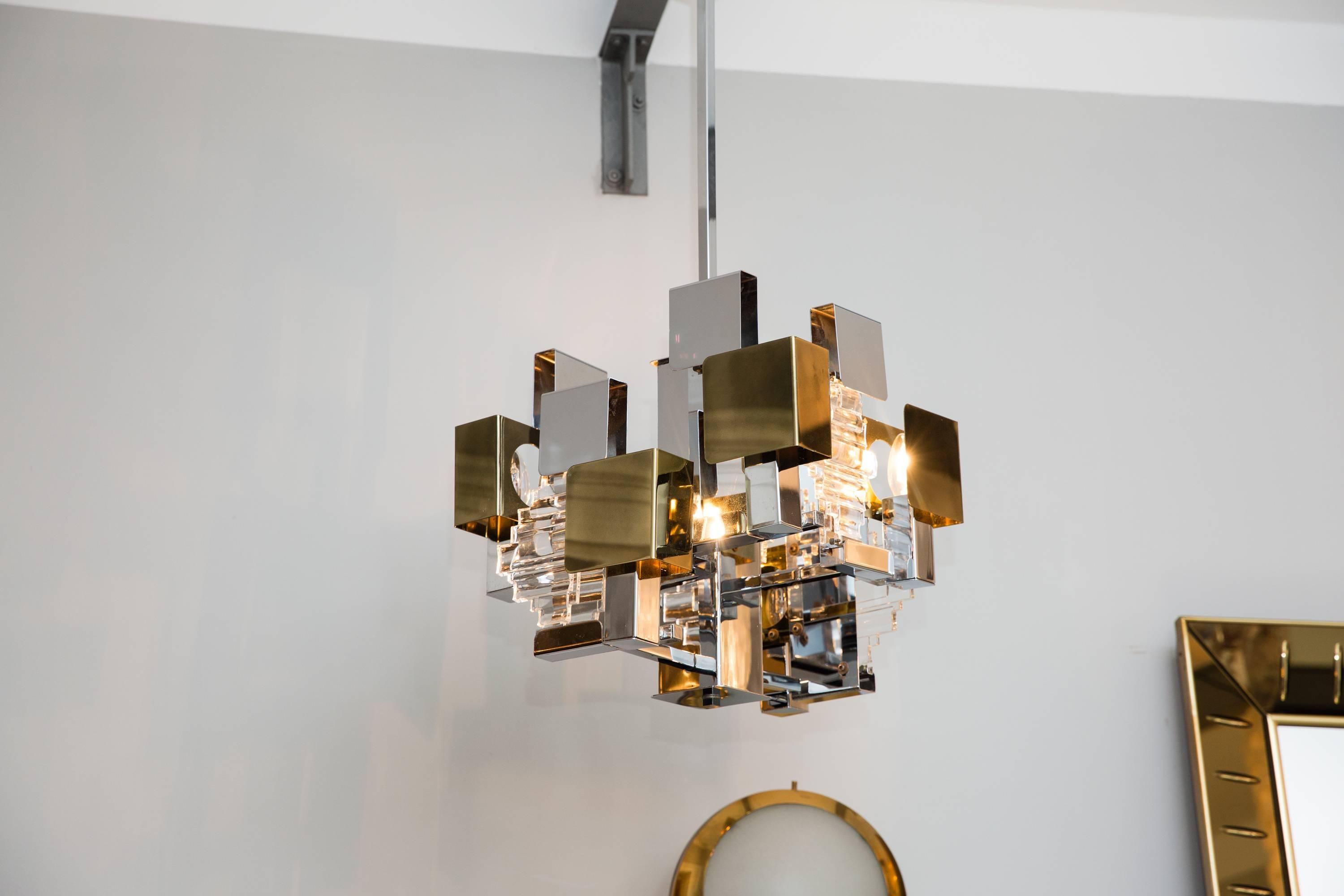 Rare futuristic chandelier by Stilkronen, Italy circa 1960, chrome, brass and glass elements, six light bulbs inside, signed with sticker by Stilkronen Made in Italy, perfect condition, brass slightly patinated, height 90 cm (adjustable), width 45