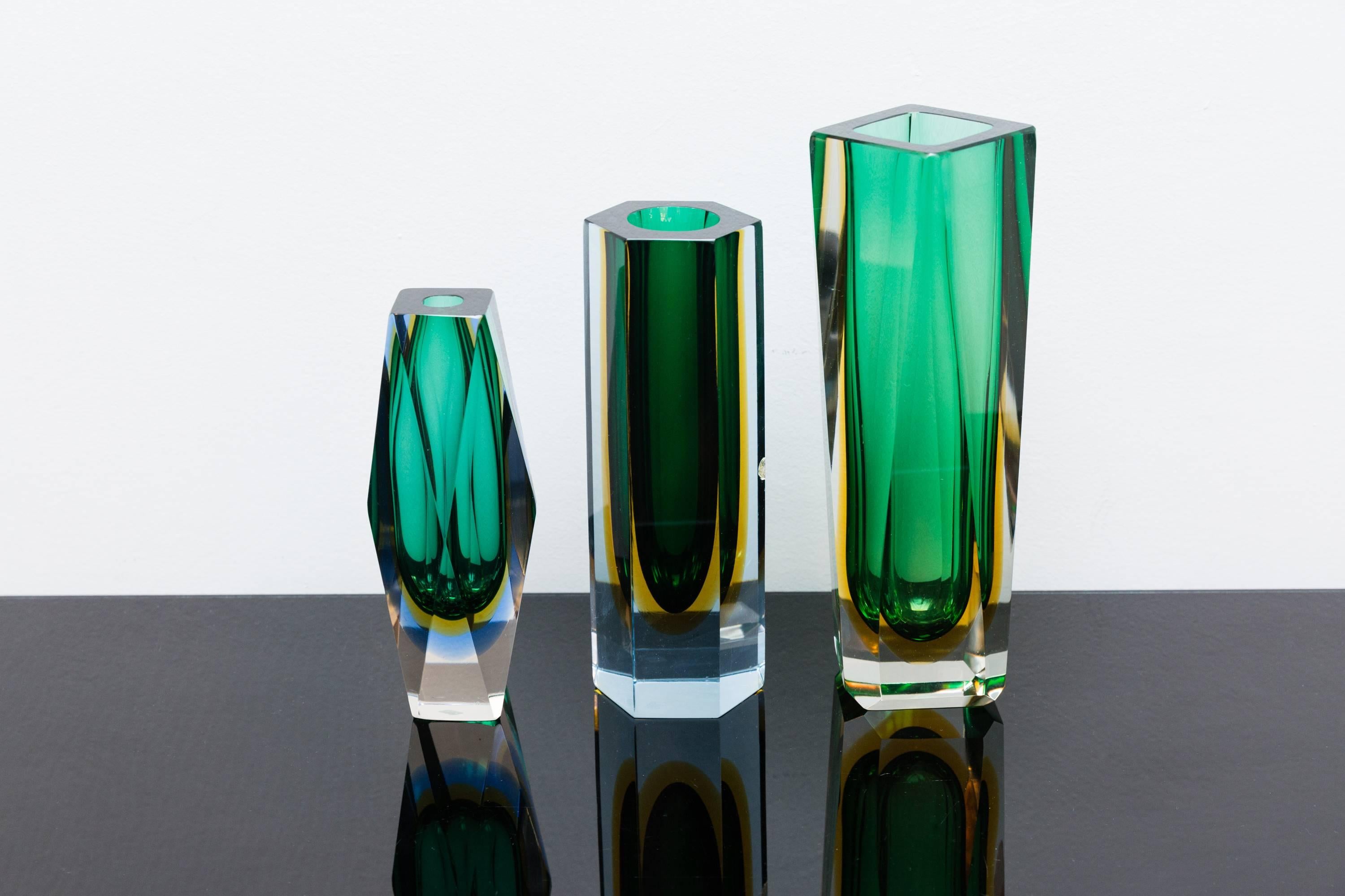 Beautiful multi-color set of three faceted vases, Murano, Italy, circa 1960, Prod. Sommerso, attributed to Alessandro Mandruzzato
Different coolers of green, amber-yellow, turquoise, dark green, light blue, into clear glass.
The vibrant colors and