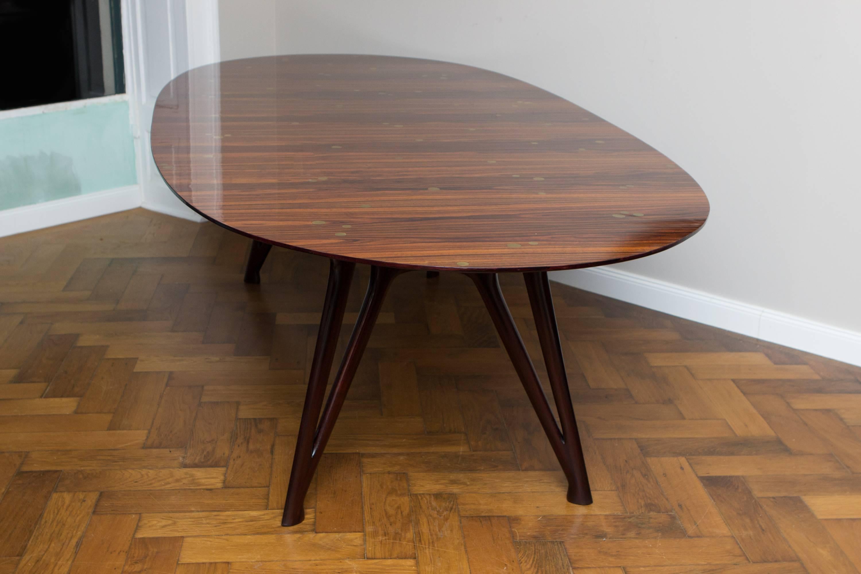 Amazing dining table, Italy circa 1950, attributed to Ico Parisi, all in all restored, elegant organic shaped dark brown ebony legs, oval polished jacaranda, rosewood table top with countless inlay brass dots in different sizes, the border of the