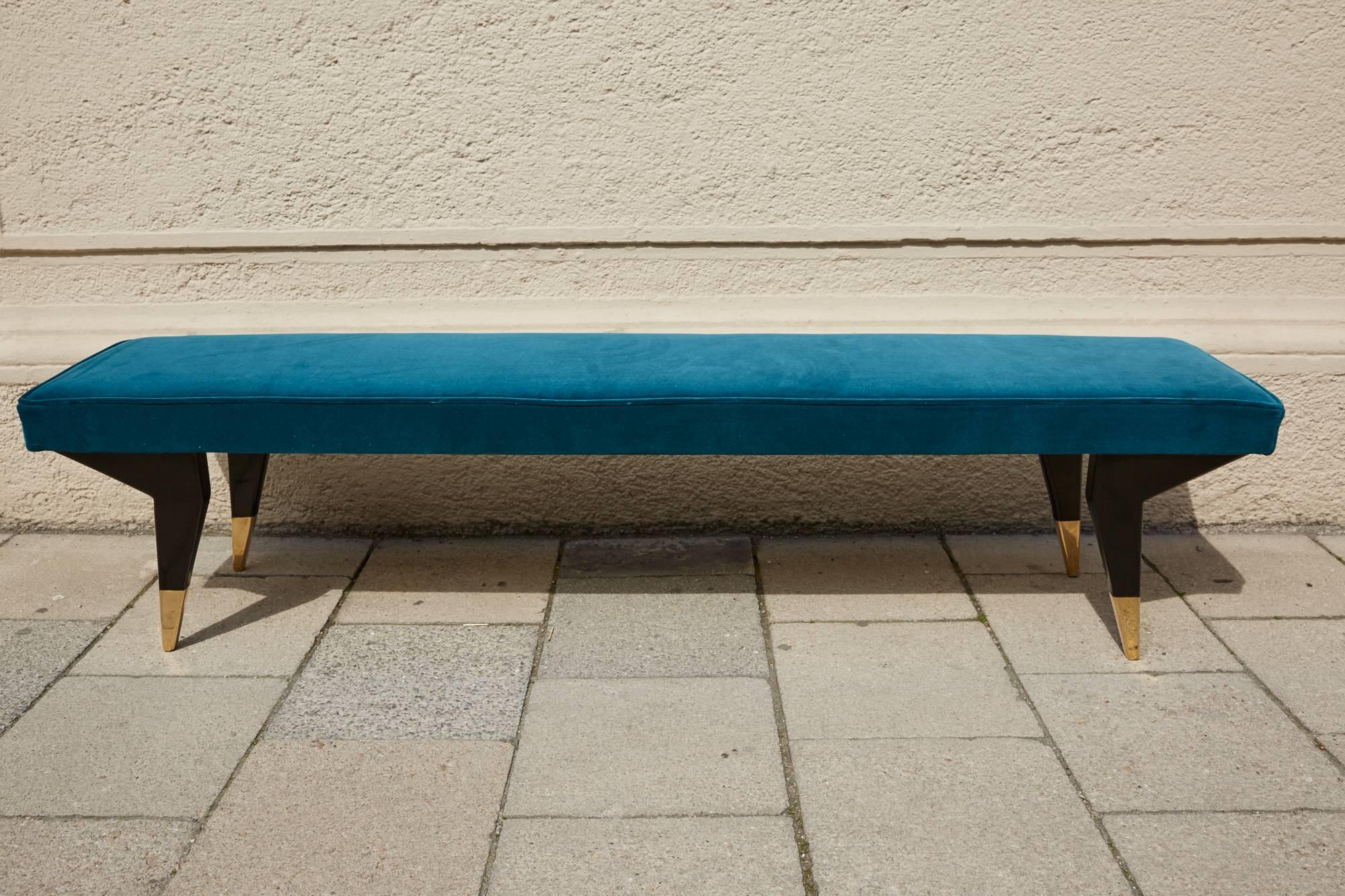 Pair of elegant padded benches, Italy, circa 1950, attributed to Ico Parisi, black shellack polished legs, massive brass legs, reupholstered with designers Guild turquoise blue velvet fabric, piping around the pad. Complete restored and ready for
