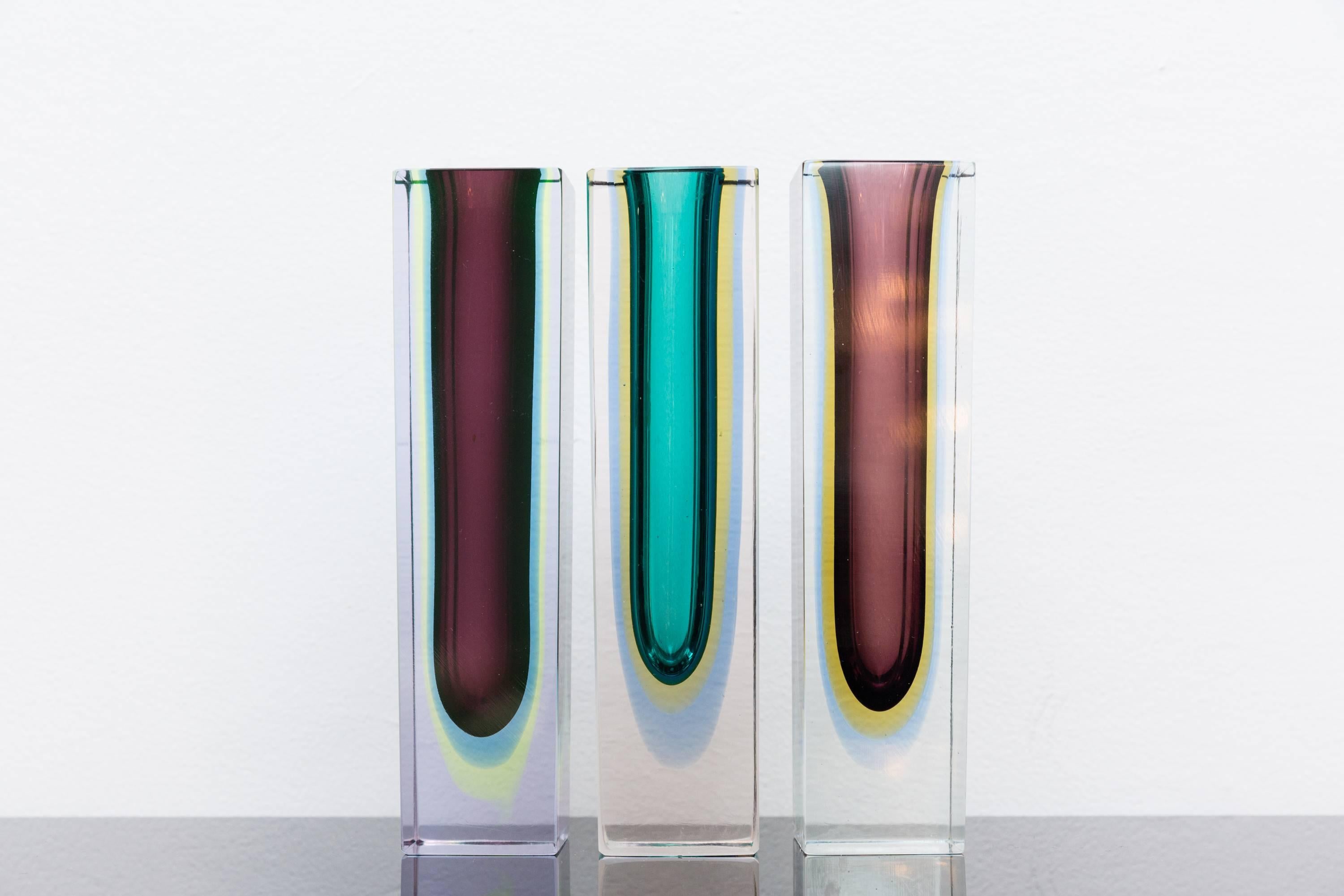 Beautiful multi-color set of three block Vases, Italy circa 1960, Prod. Seguso, Murano by Flavio Poli 
1. Very rare four color in one vase: amber-yellow, turquoise, dark purple cased into pink glass 
2. amber, yellow, light blue, cased into clear