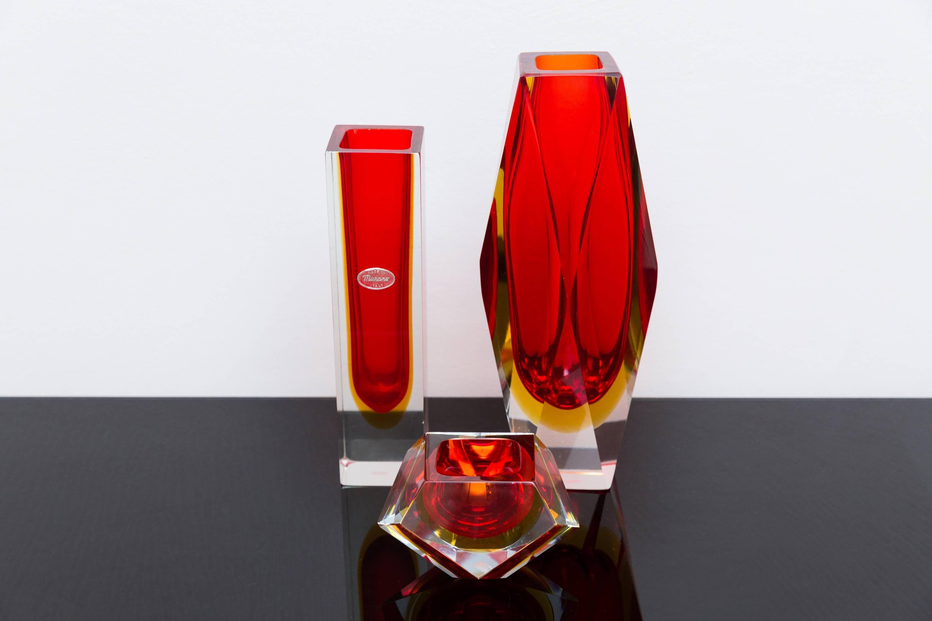 Set of three red color Murano glass vases, Prod. Sommerso, Italy, circa 1960
Big red and orange vase measures height 30 cm, width 12 cm
Smaller red and orange block vase, marked with the original Murano glass sticker, height 25 cm, width 6,5