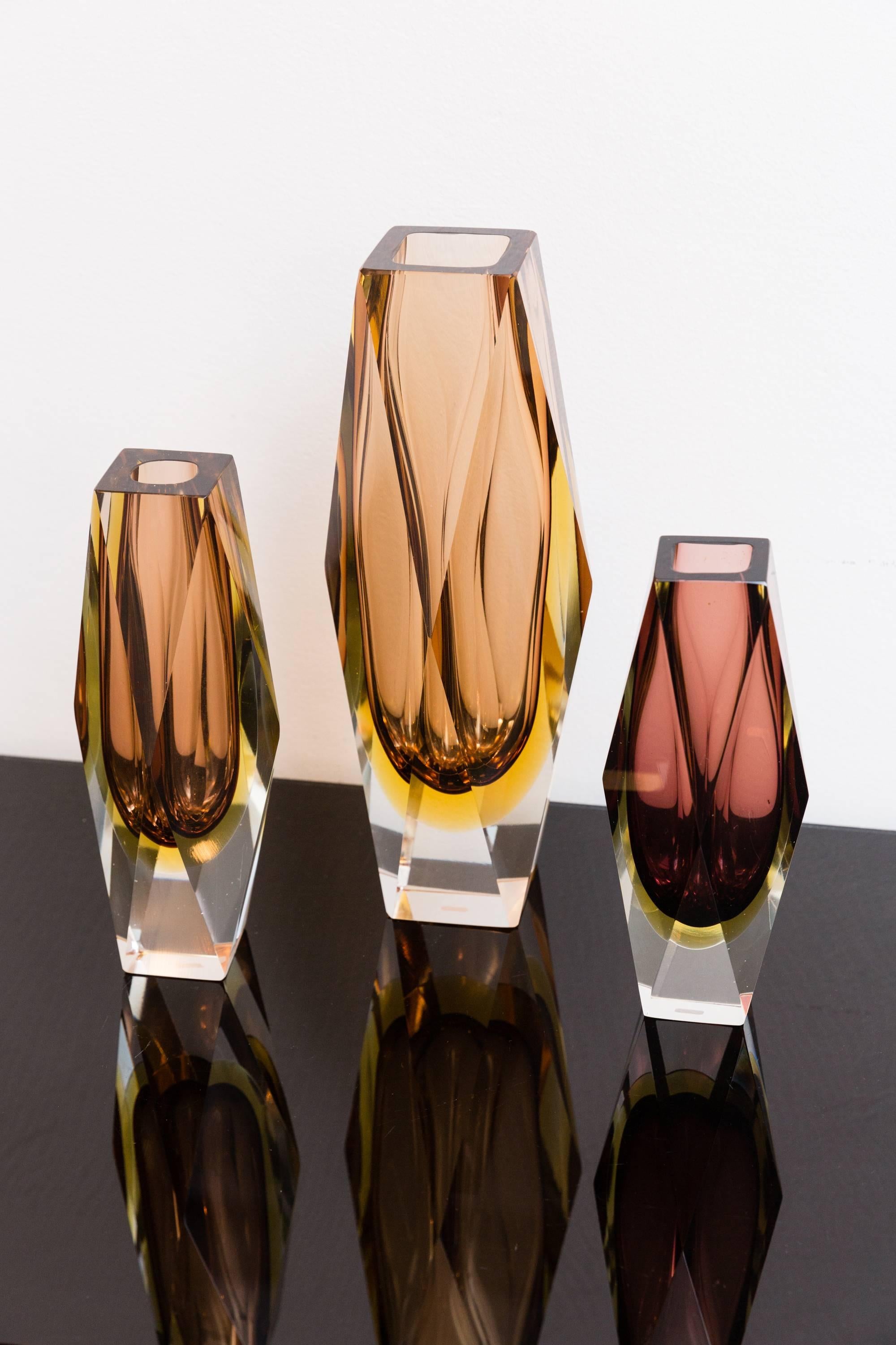 Beautiful multi-color set of three faceted / block vases, Murano, Italy, circa 1960, Prod. Sommerso, attributed to Alessandro Mandruzzato
Different colors by orange, amber-yellow, purple, into clear glass.
The vibrant colors and the different