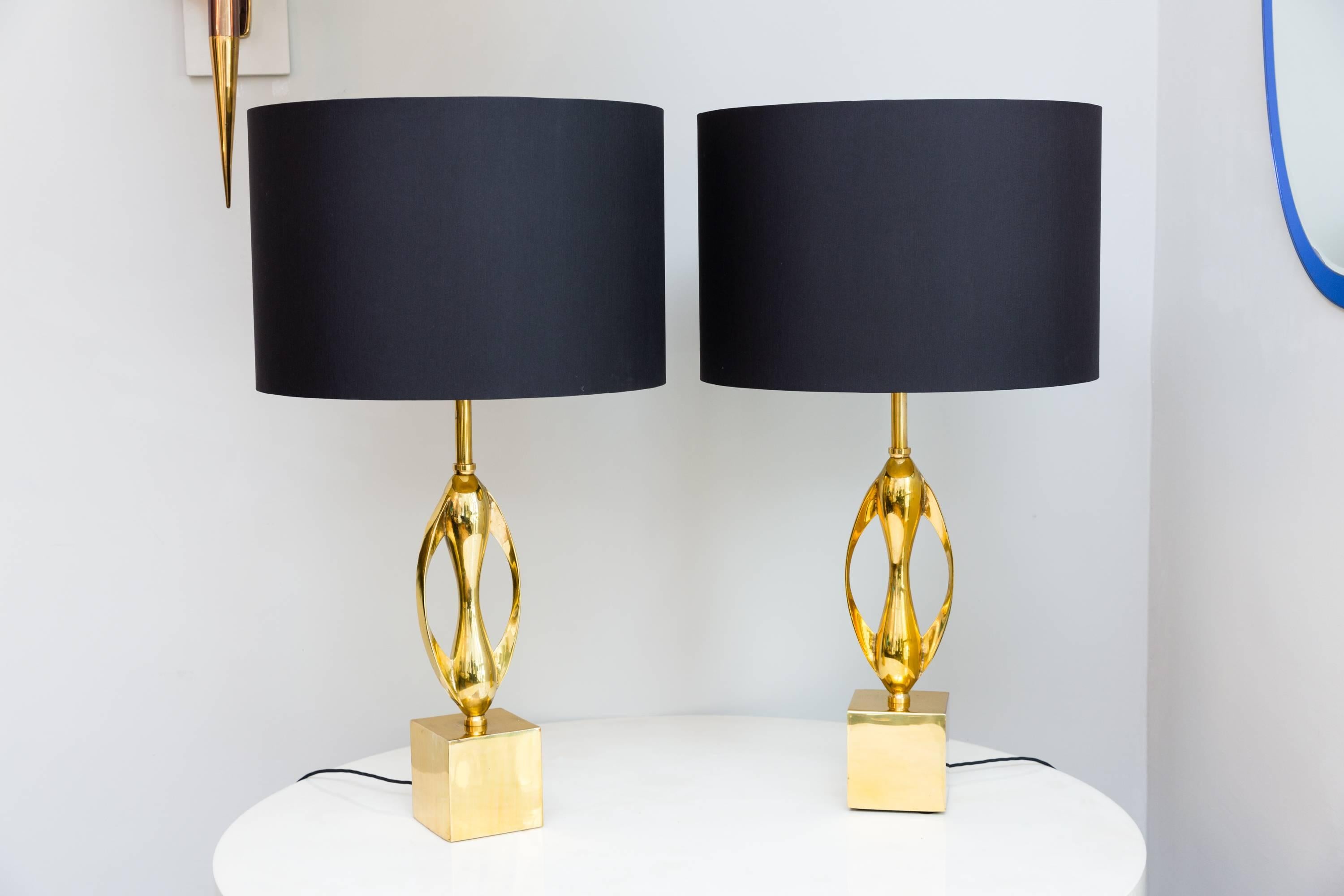 Beautiful pair of table lamps by Maison Charles, Paris, France, circa 1970, heavy solid brass, elegant brass sculpture shape, rewired with black cotton cable, new handmade black silk shade inside golden.
New polished surface, some slight oxidation