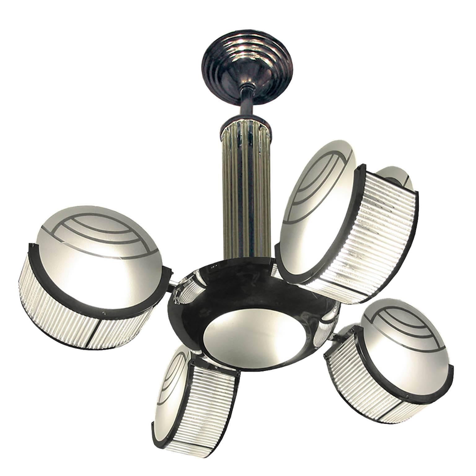 Very Rare Genuine Art Deco Petitot Chandelier

Modernist ceiling lamp with four arms shaped as chromed metal circles, holding satinated glass disks with Art Deco pattern and glass rods.
France, circa 1940.

Dimensions:
Height: 70 cm (27.56
