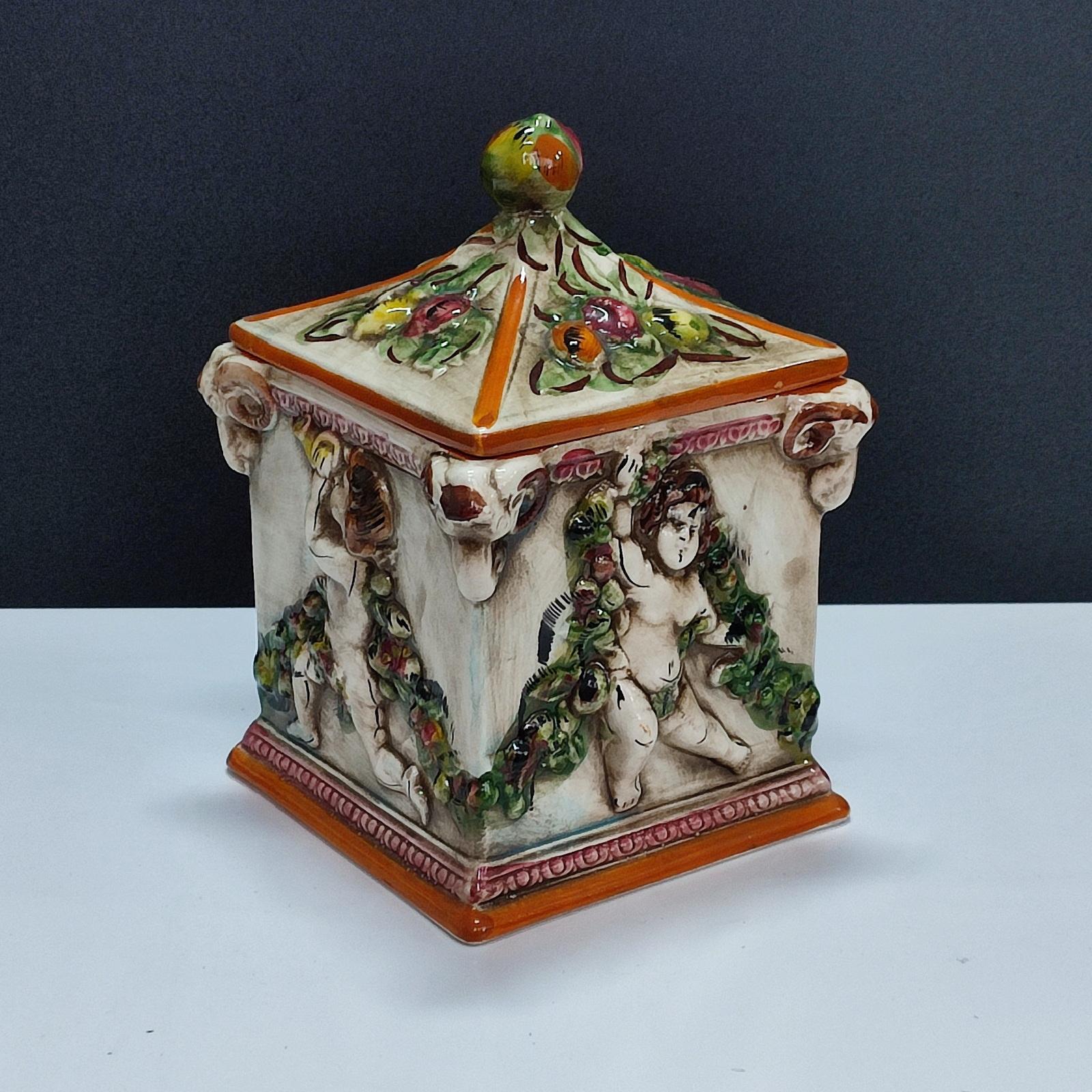 Capodimonte Lidded Jar Four Seasons Cherubs Decor. Vintage Italian biscotti jar from the 1950s, handmade and hand-painted. It is a lovely piece that can also be used to decorate your home. Marked Capdimonte on the bottom.
Good overall condition, it