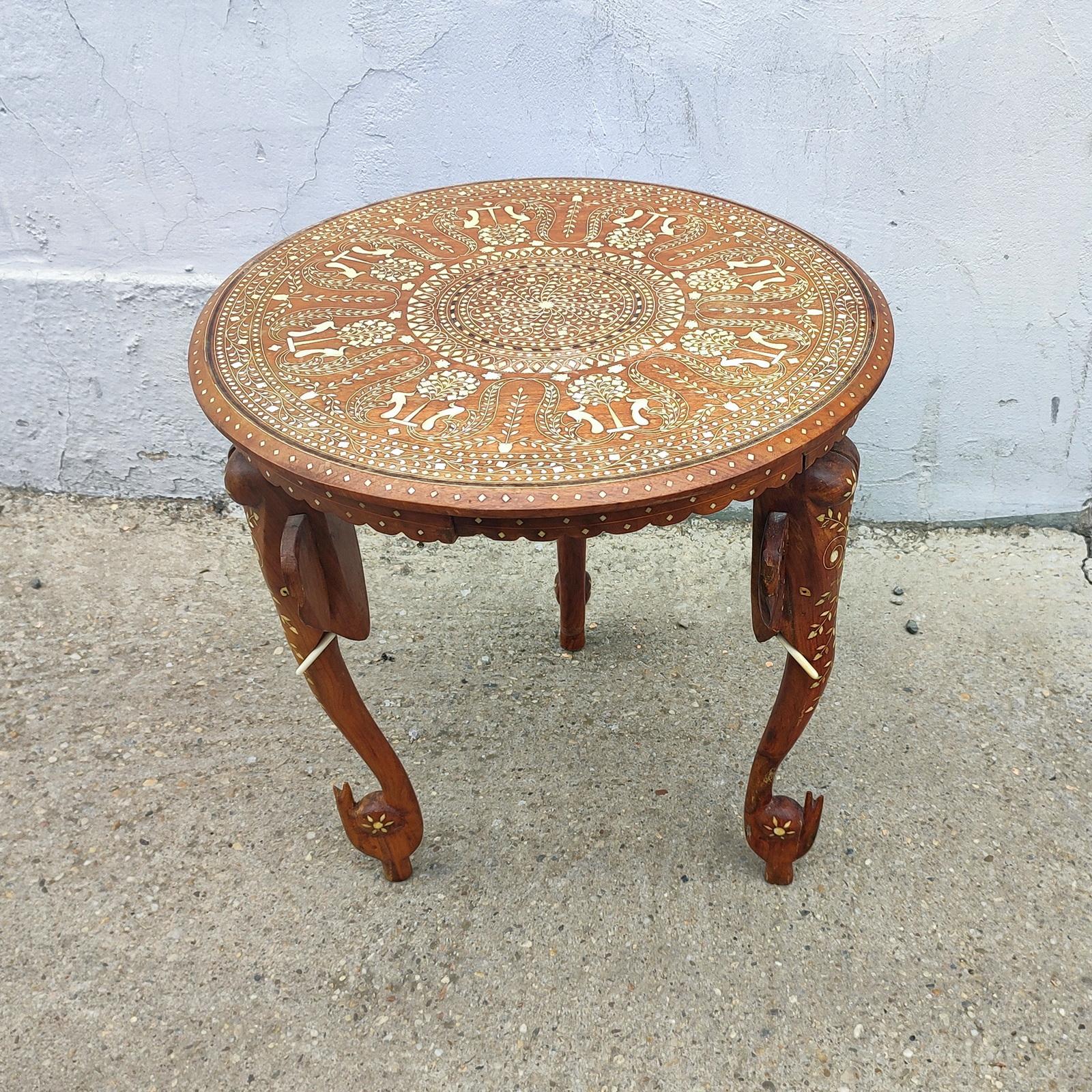 Anglo-Indian Mughal Teak Inlaid Round Side Table.
A refined and elegant round side table that is hand-carved with bone inlaid and has an elaborate peacock and tree design.
With bone inlaid figurative details, resting on the three supporting legs,