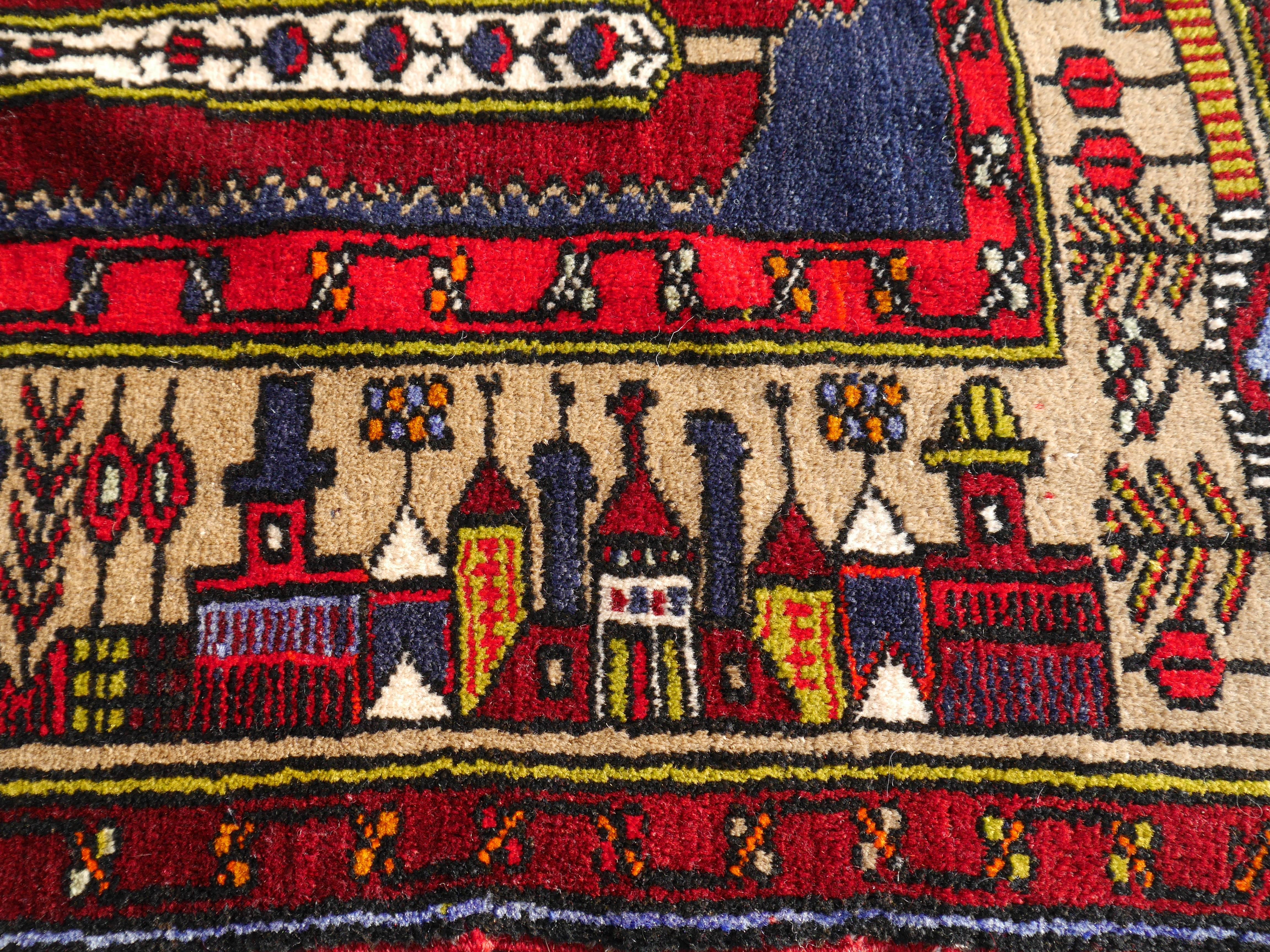Beautiful and unusual small village rug from Turkey. This type of rug is described as wedding rug since there are young women who make pieces with the buildings of her home village. She can take 