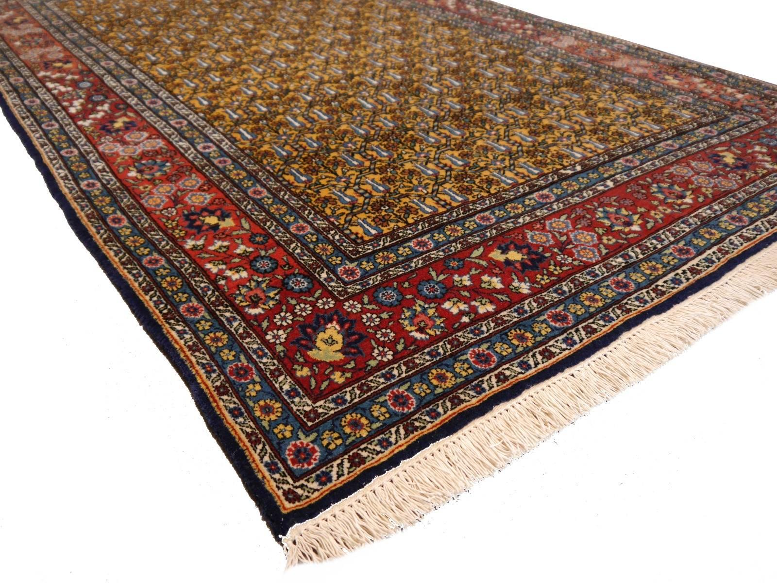 Very beautiful and unusual Turkish Hereke rug, hand-knotted using best lamb’s wool. Unique color combination with mustard colored inner filed decorated with trees of life and blue tulips. This rug is very fine and densely knotted using the Turkish