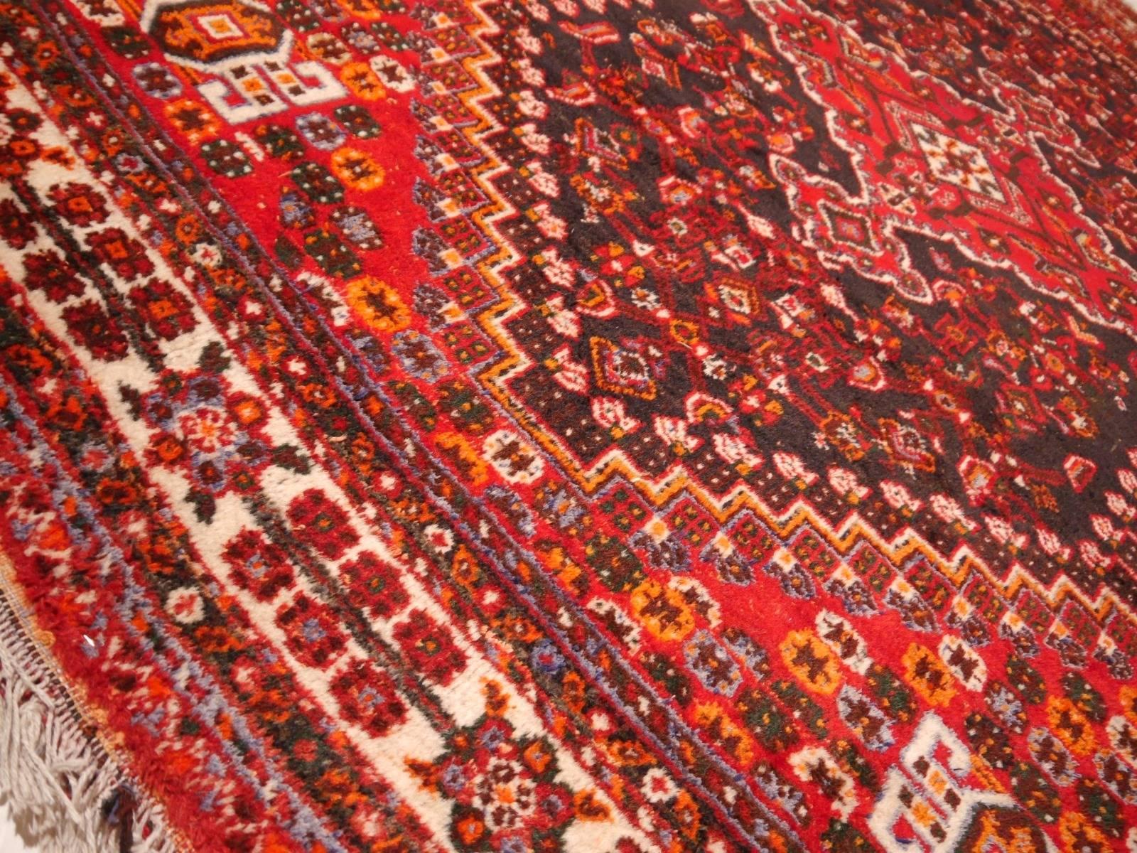 Beautiful hand-knotted tribal Persian rug from the Qashqai tribe in South Persia. Pile and warp are made of original highland wool. The rug shows traditional designs.