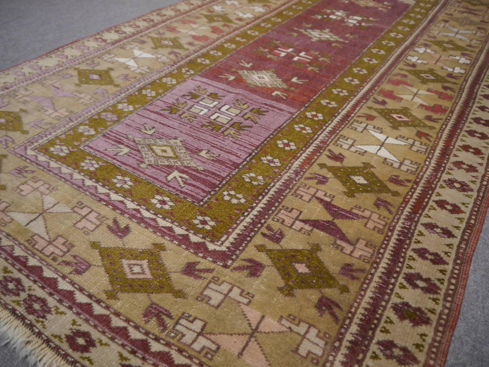Hand-knotted Turkish Melas rug with unusual colors. 
This beautiful vintage rug was hand knotted by women in the village of Melas in the western antatolian district in Turkey. It is a traditional runner size with a prayer rug design. It has very