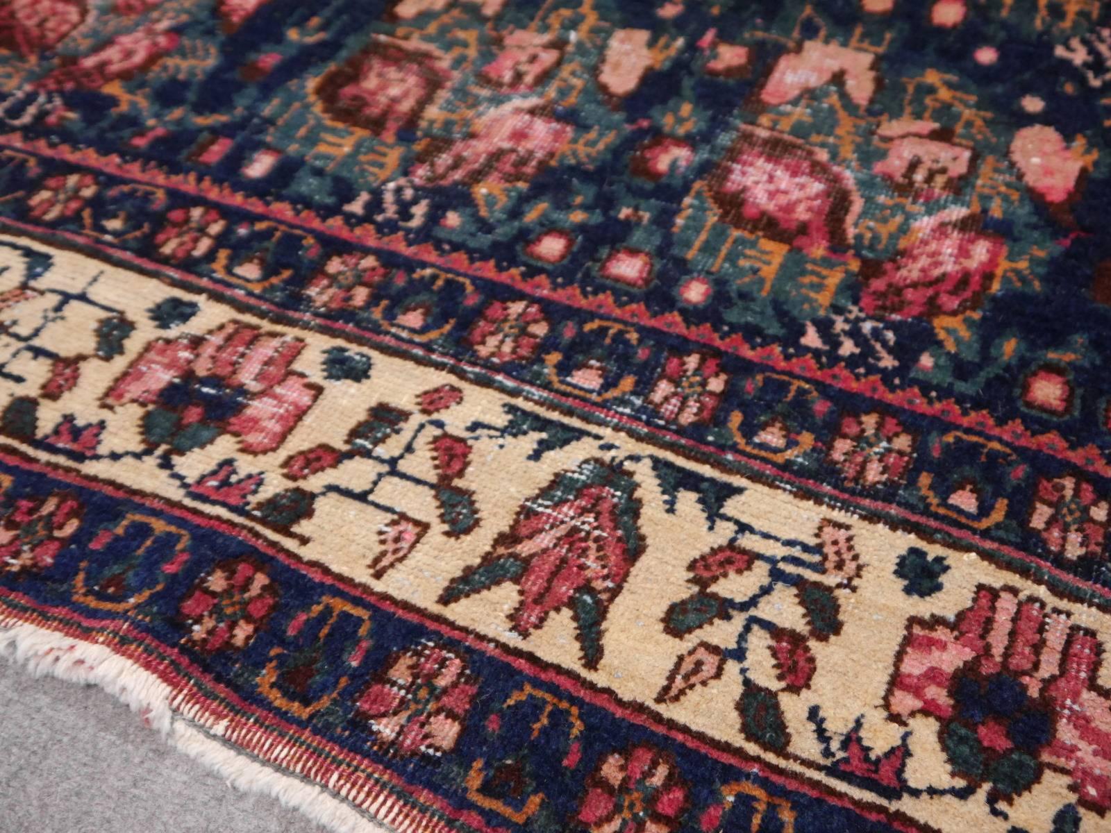 A beautiful vintage rug in looked after distressed condition. Add a great used look to your interior design with this hand-knotted 1950s carpet. The rug has perfectly worn areas and signs of its life - image it could tell all the things it has seen