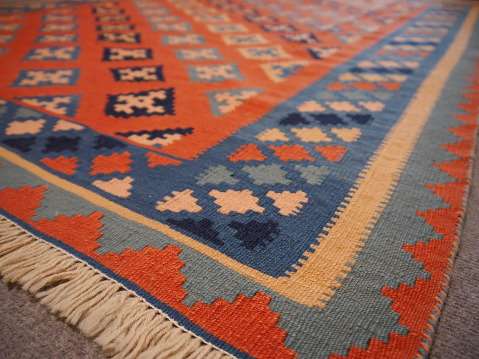 This handwoven Persian Kilim rug was hand woven by women of the Qashqai tribe in southwest Persia. 

Qashgai tribal Kilim rugs are always decorative and colorful works of art, mainly using the colors red (made from the Ronnas plant), blue (from