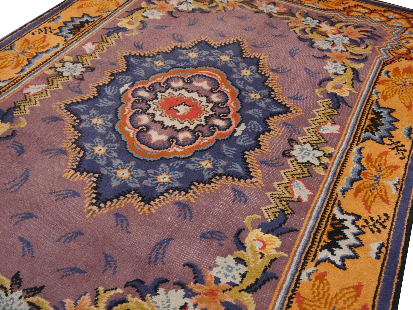 This unusual colored rug was hand-knotted in a French workshop in the time changing from Art Nouveau to Art Deco. It has a pile made of wool and is in beautiful vintage condition. 

 