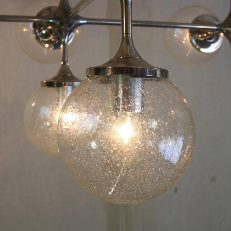 Ceiling or wall lamp, designed by Peter Rockel, East Germany, 1976.

Large ceiling lamp with 12 light fittings and glass balls designed for the Palast Der Republik in East Berlin. This light module was part of the light super structure in the main